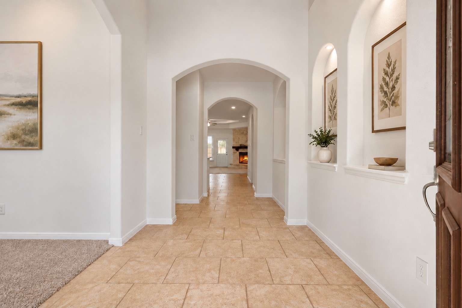 Elegant Details Around Every Corner! This lovely entry hallway showcases high ceilings, beautiful tile flooring, graceful arches, and charming lighted art niches. The long, welcoming hallway creates a wonderful flow through the home while giving you pretty glimpses of the living spaces beyond. Bright, open, and beautifully finished! *Photo is virtually staged* Elegant Details Around Every Corner! This lovely entry hallway showcases high ceilings, beautiful tile flooring, graceful arches, and charming lighted art niches. The long, welcoming hallway creates a wonderful flow through the home while giving you pretty glimpses of the living spaces beyond. Bright, open, and beautifully finished! *Photo is virtually staged*
