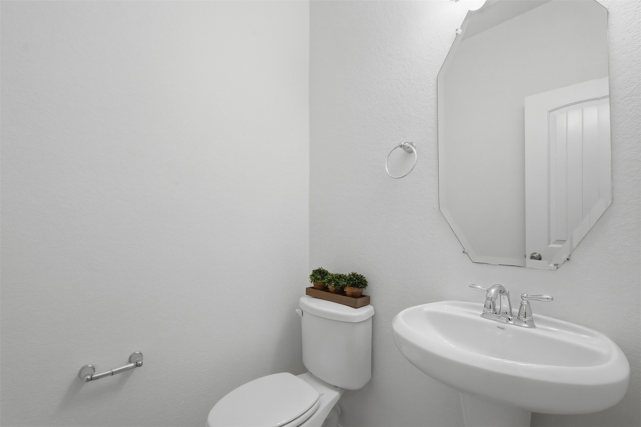 A Lovely & Convenient Powder Room! This beautifully finished half bath offers a clean, bright, and welcoming space for family and guests. The elegant vanity, framed mirror, and simple dcor add a polished touch to this convenient first-floor powder room.