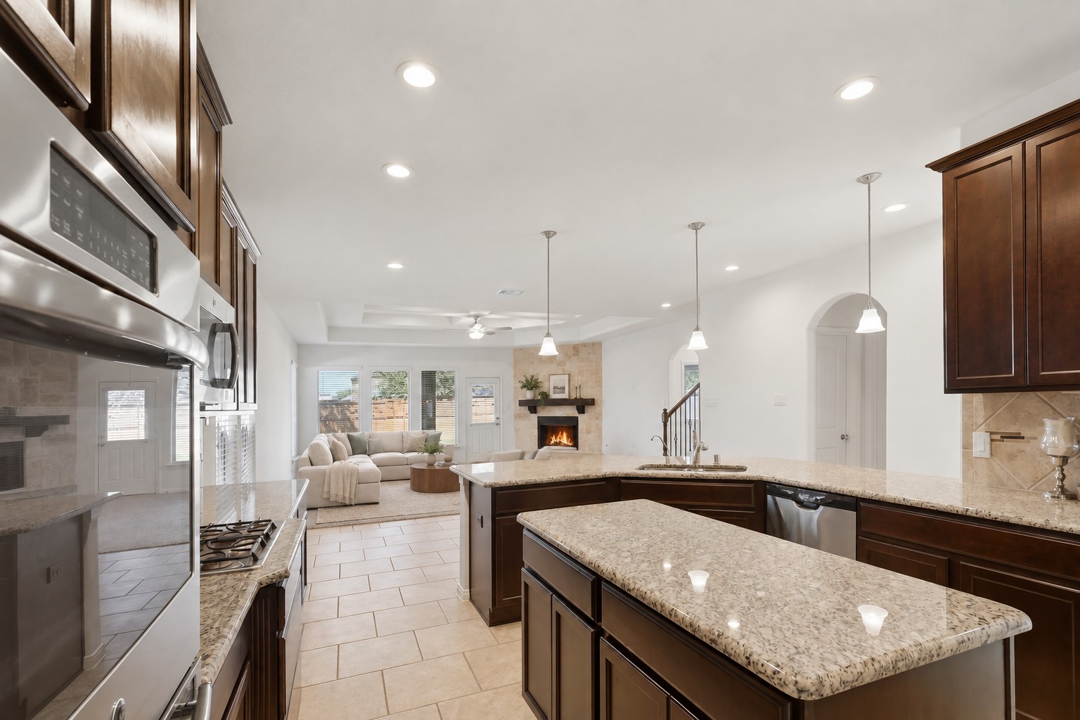 Room to Cook, Gather & Enjoy! The spacious kitchen island provides an abundance of countertop space and a wonderful place for family and guests to gather. Beautiful granite counters, tall custom cabinetry, stainless steel appliances, double ovens, and recessed lighting give this kitchen both style and functionality. *Photo is virtually staged*