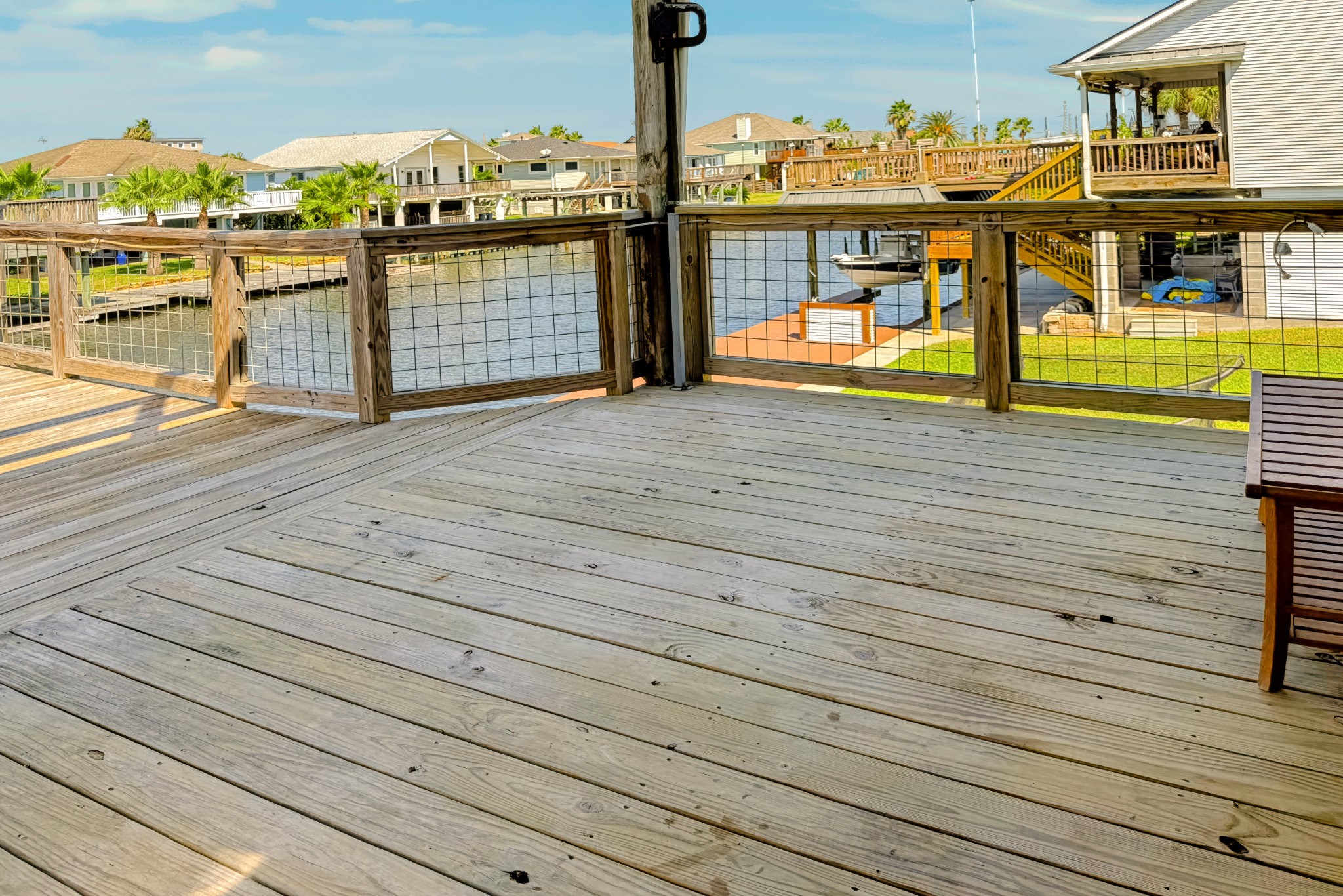COVERED BACK DECK AREA AT BACK DOOR OF HOUSE, GREAT AREA TO SIT AND WATCH THE BOATS GO BY