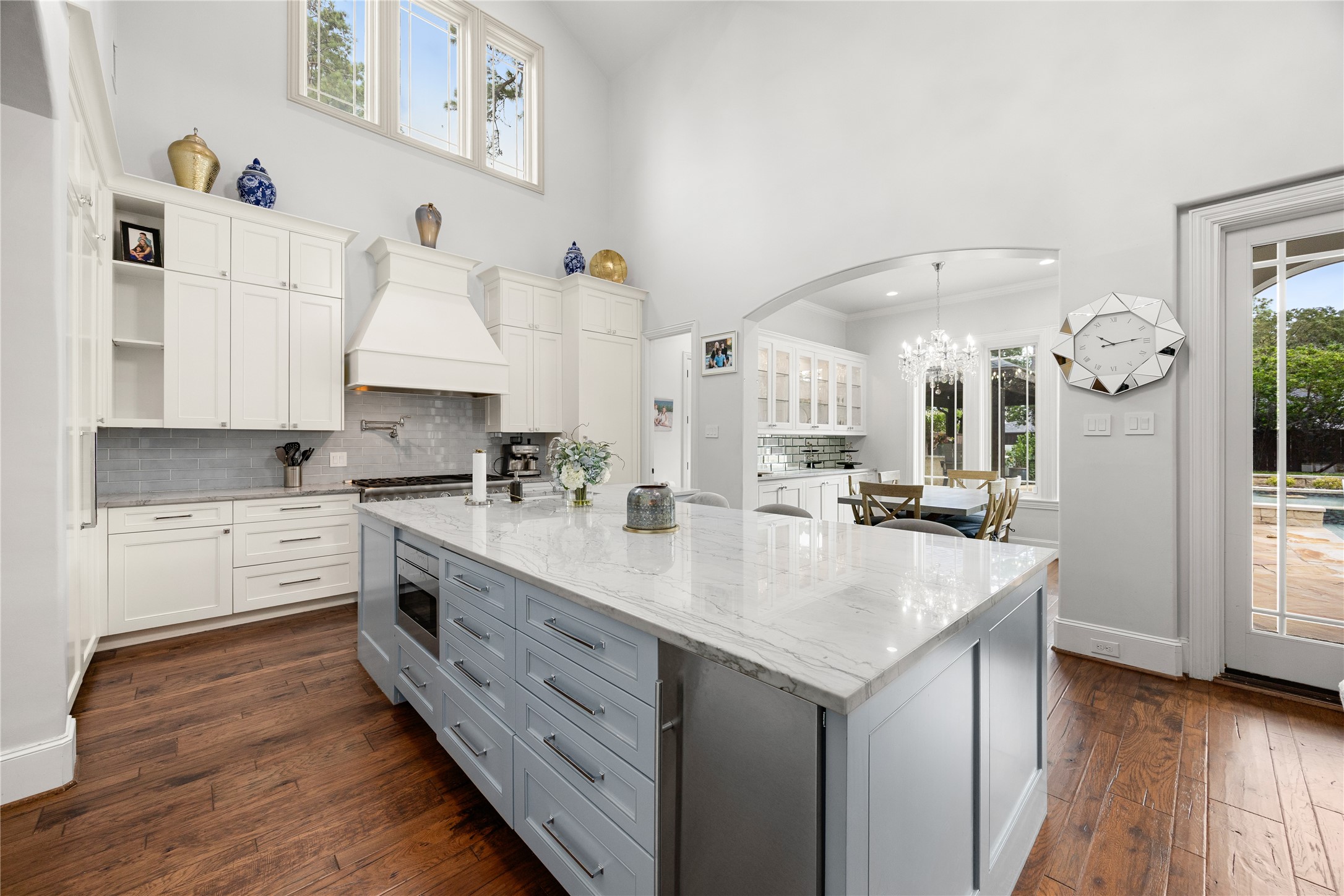 Updated Kitchen is open to the family room and the breakfast room. Paneled and stainless steel appliances, large island with counter height seating. A pool bath is in the back corner.