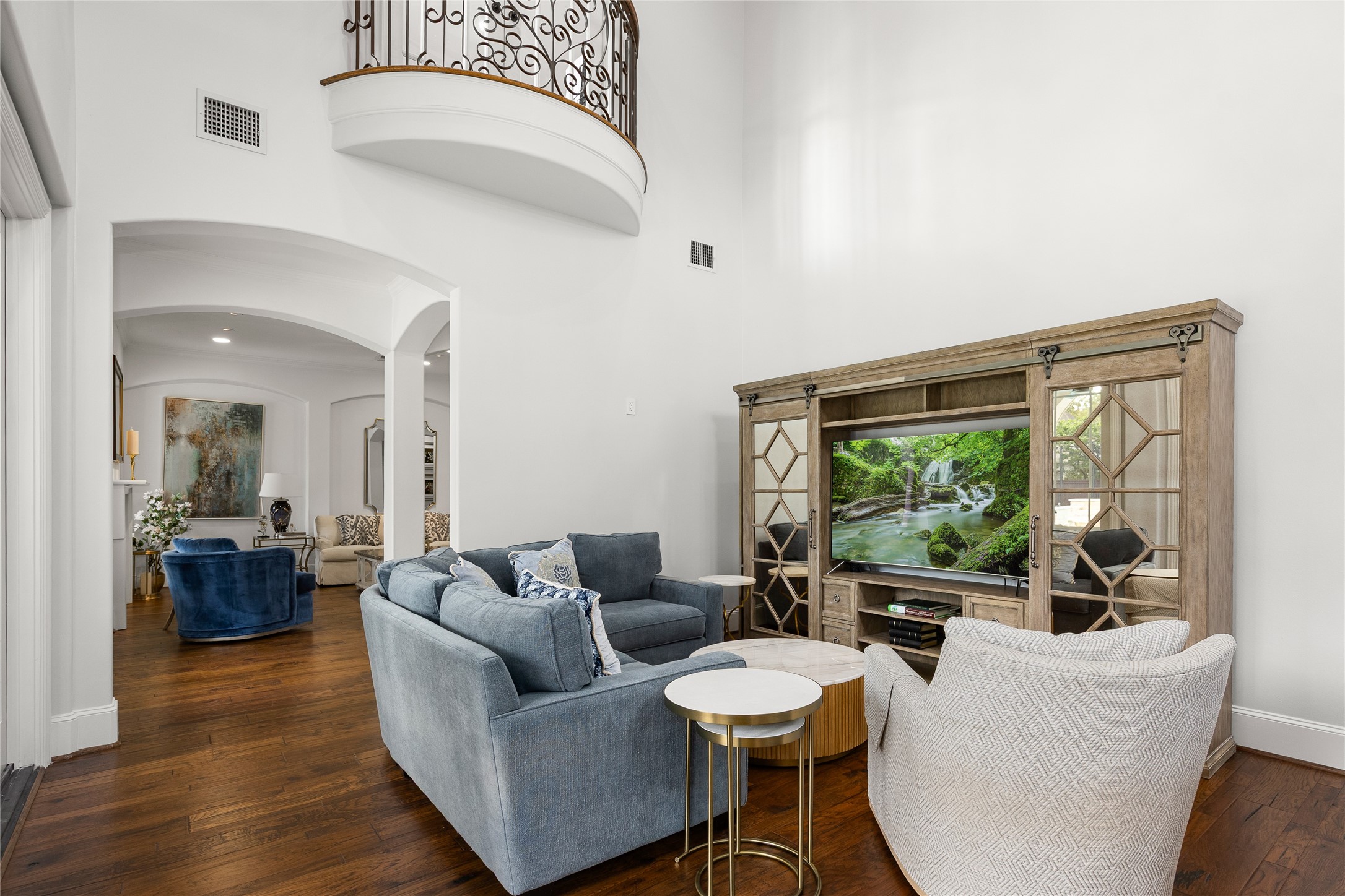 The Family room and Kitchen have a Juliet Balcony overhead, accessible from the Game Room. The Formal Living room is just past the Family room.