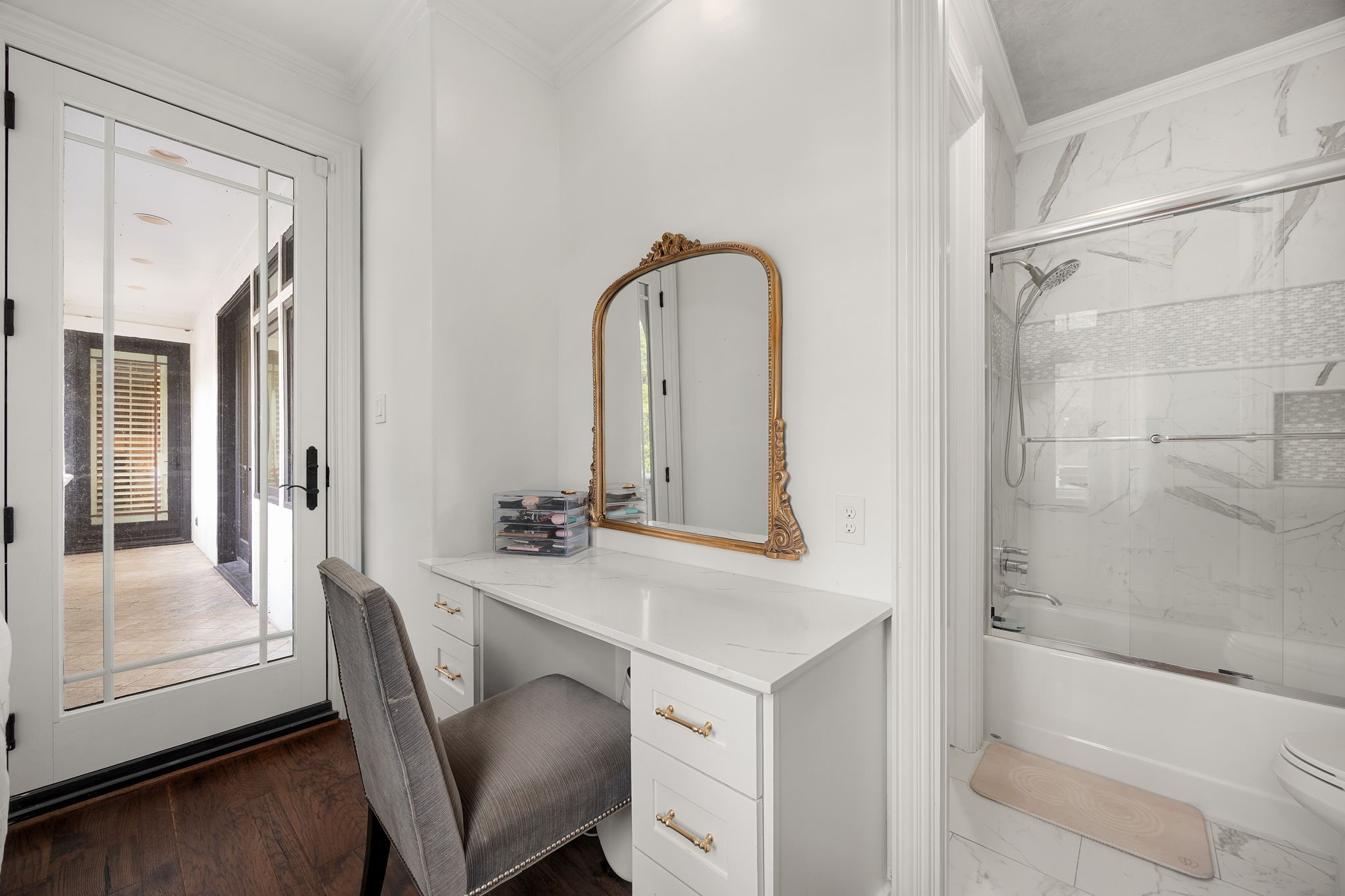 Vanity area with balcony access and a tub/shower combo.