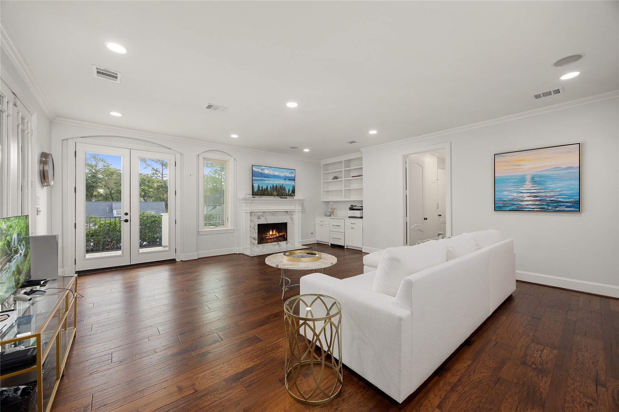 Spacious Game Room has balcony access overlooking the backyard, a fireplace built in cabinets and two spacious closets.