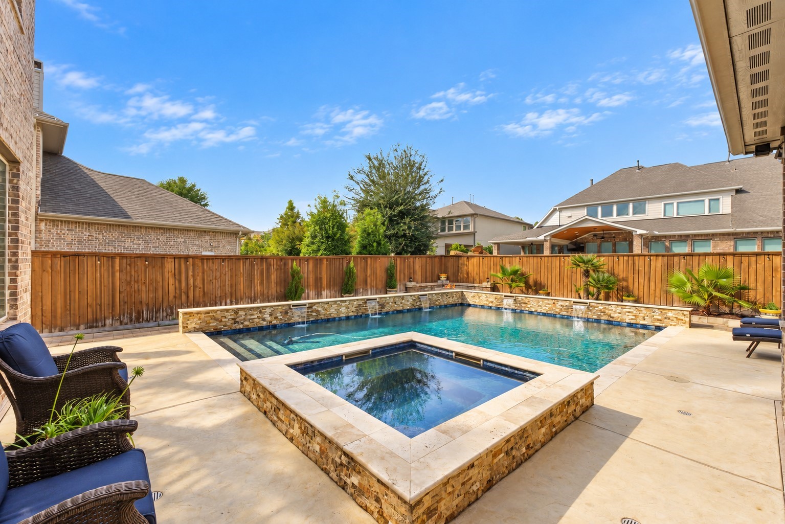 Welcome to your own private backyard paradise! Featuring a stunning swimming pool, raised spa, beautiful stonework, and spacious patio areas perfect for outdoor entertaining!