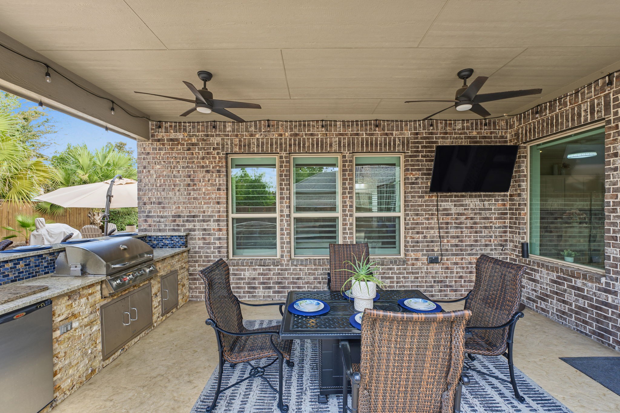 Enjoy outdoor living at its finest with an expansive paver patio, beautiful tropical landscaping, a sparkling pool, and a multiple spacious outdoor dining area, perfect for entertaining guests, hosting family gatherings, or simply relaxing in your private backyard retreat!