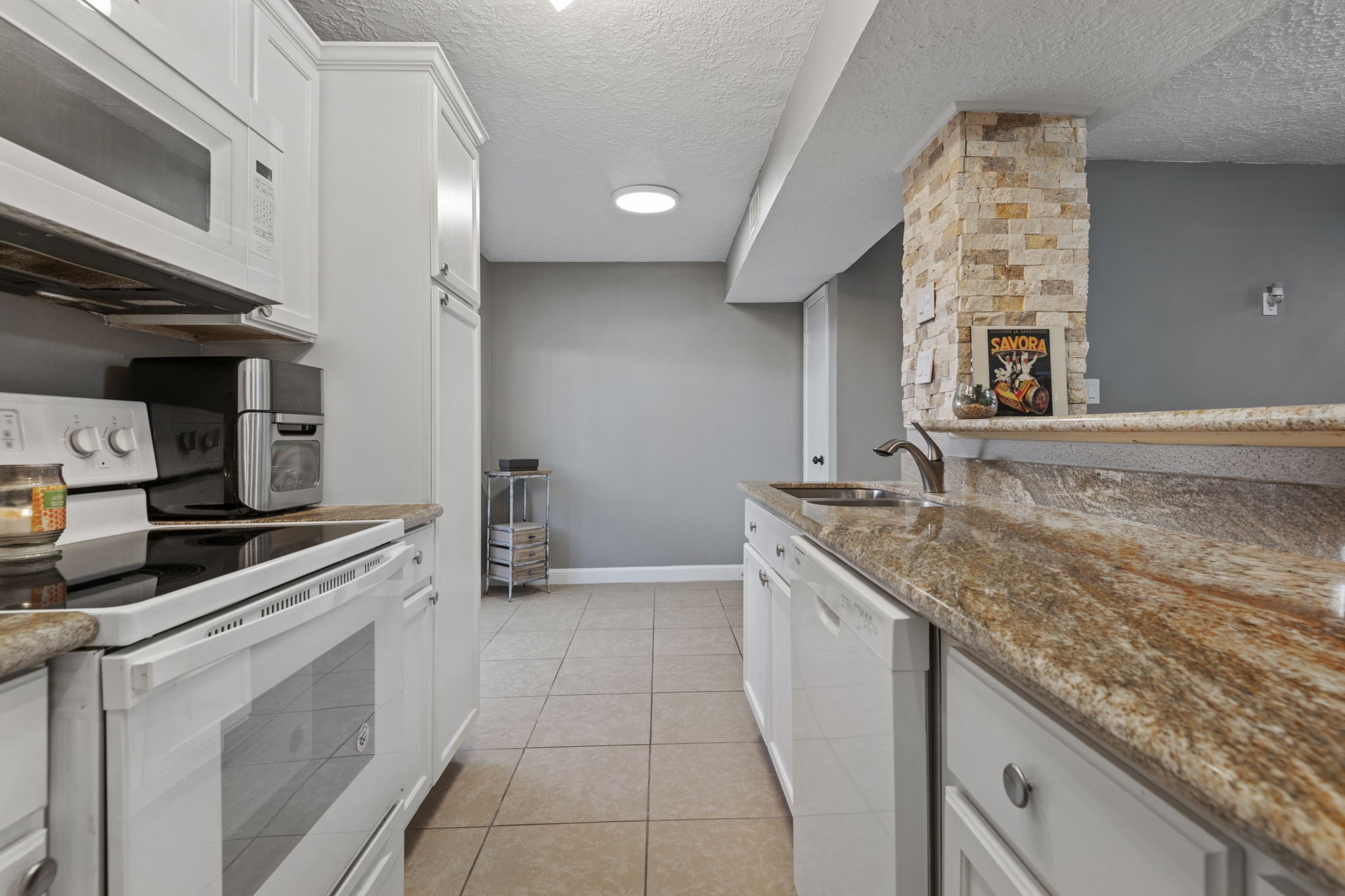 There is plenty of room beyond the kitchen for a breakfast table. There is plenty of room beyond the kitchen for a breakfast table.