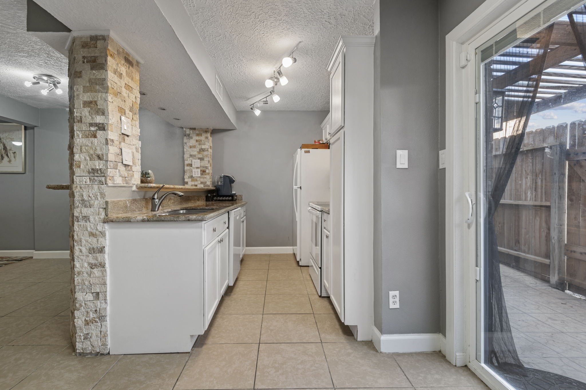 The kitchen features granite countertops, recently installed dishwasher, electric cooktop and stove, microwave, and fridge. The kitchen features granite countertops, recently installed dishwasher, electric cooktop and stove, microwave, and fridge.
