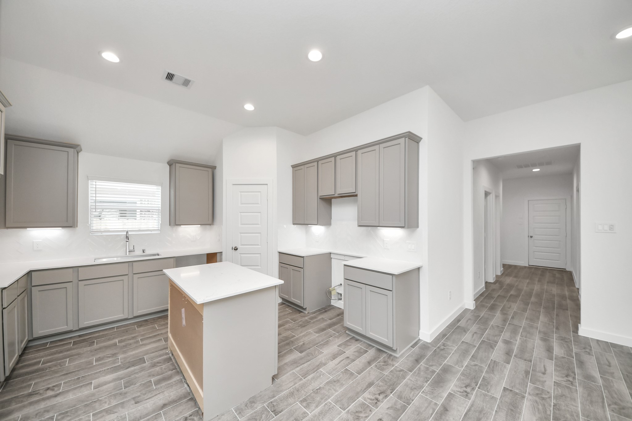 This kitchen is by far any chefs dream! This spacious kitchen features high ceilings, stained wood cabinets, granite countertop, SS appliances, modern tile backsplash, recessed lighting, extended counter space, granite kitchen island, and space for breakfast bar, and a walk-in pantry all overlooking your huge family room. Sample photo of completed home with similar floor plan. Actual colors and selections may vary.