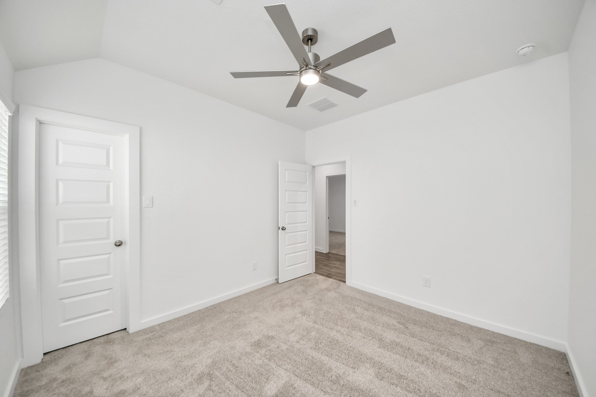 Generously sized secondary bedrooms featuring spacious closets, soft and inviting carpeting underfoot, large windows allowing plenty of natural light, and the added touch of privacy blinds for your personal retreat. Sample photo of completed home with similar floor plan. Actual colors and selections may vary.