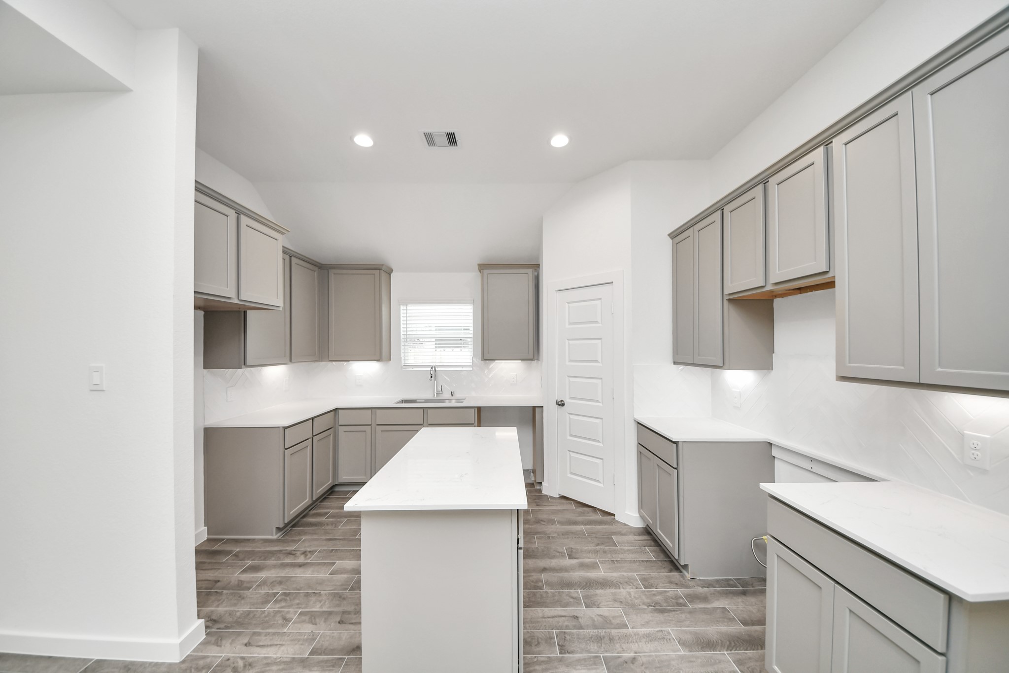 The kitchen is a culinary haven, featuring granite countertops, a tile backsplash, stainless steel appliances, 42 upper cabinets, and undercabinet lighting. Sample photo of completed home with similar floor plan. Actual colors and selections may vary.