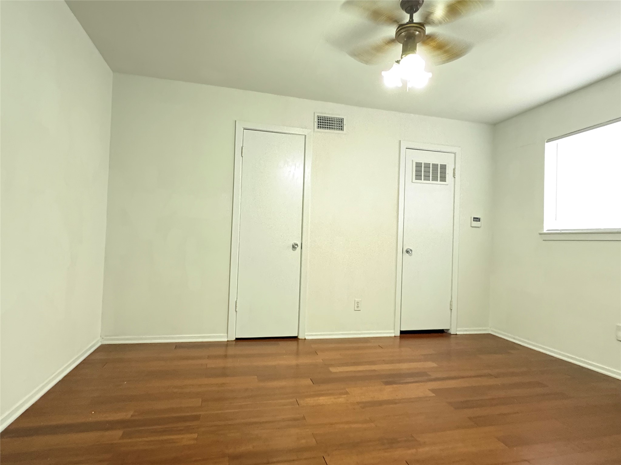 Bedroom space with Wood Flooring