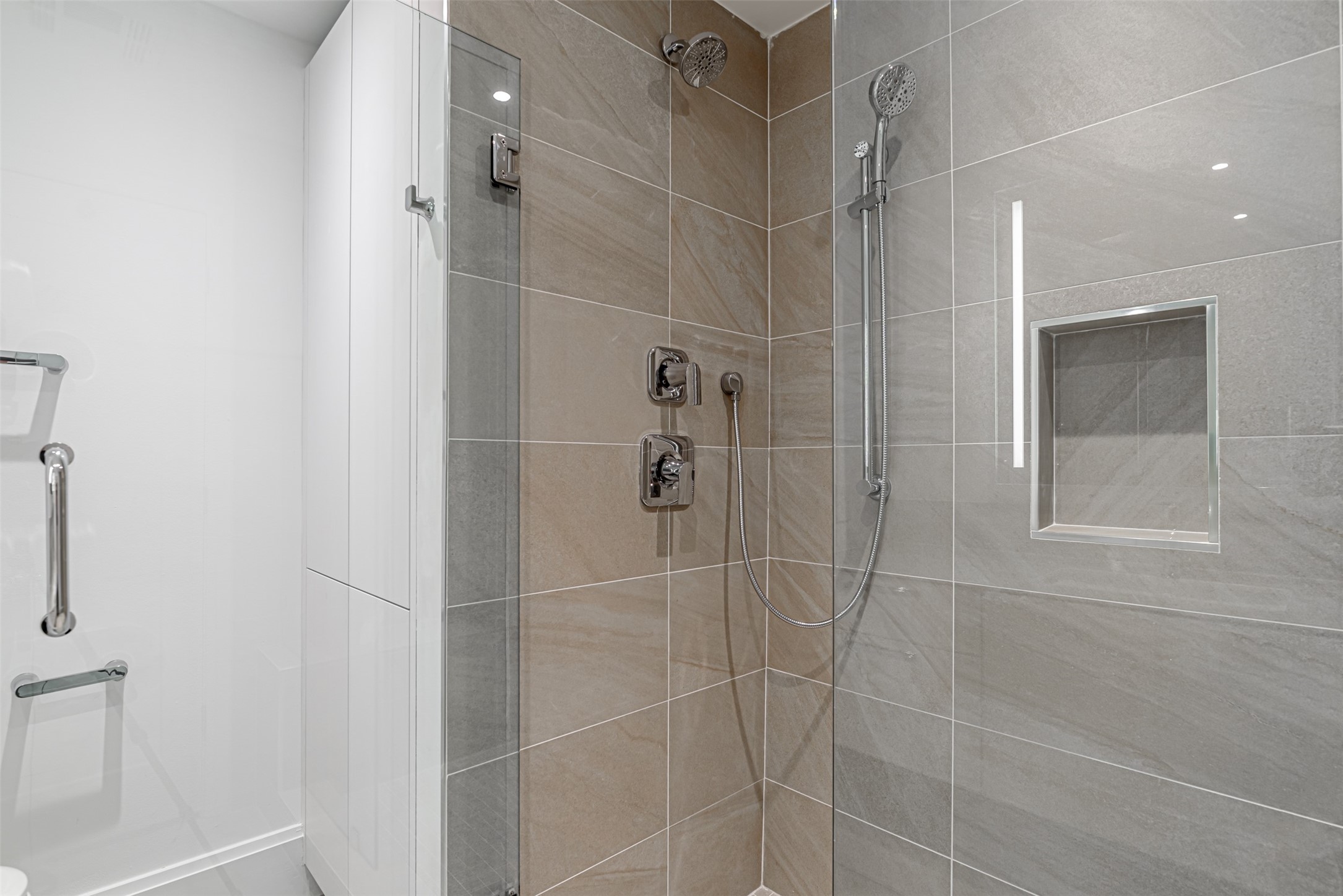 Huge walk in shower with tile surround.
