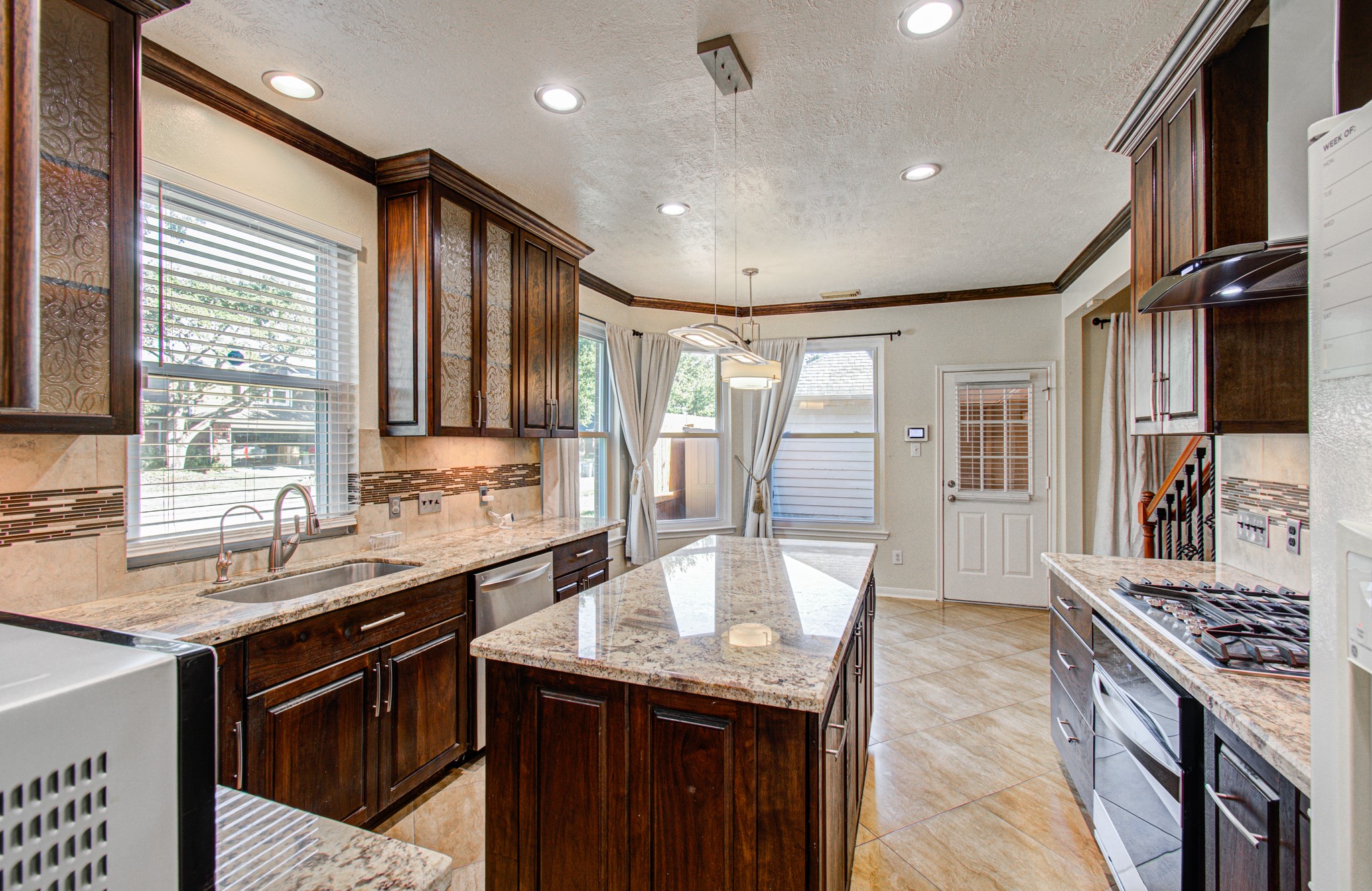 Can you even believe this beautiful kitchen with oversized island and wood cabinetry?