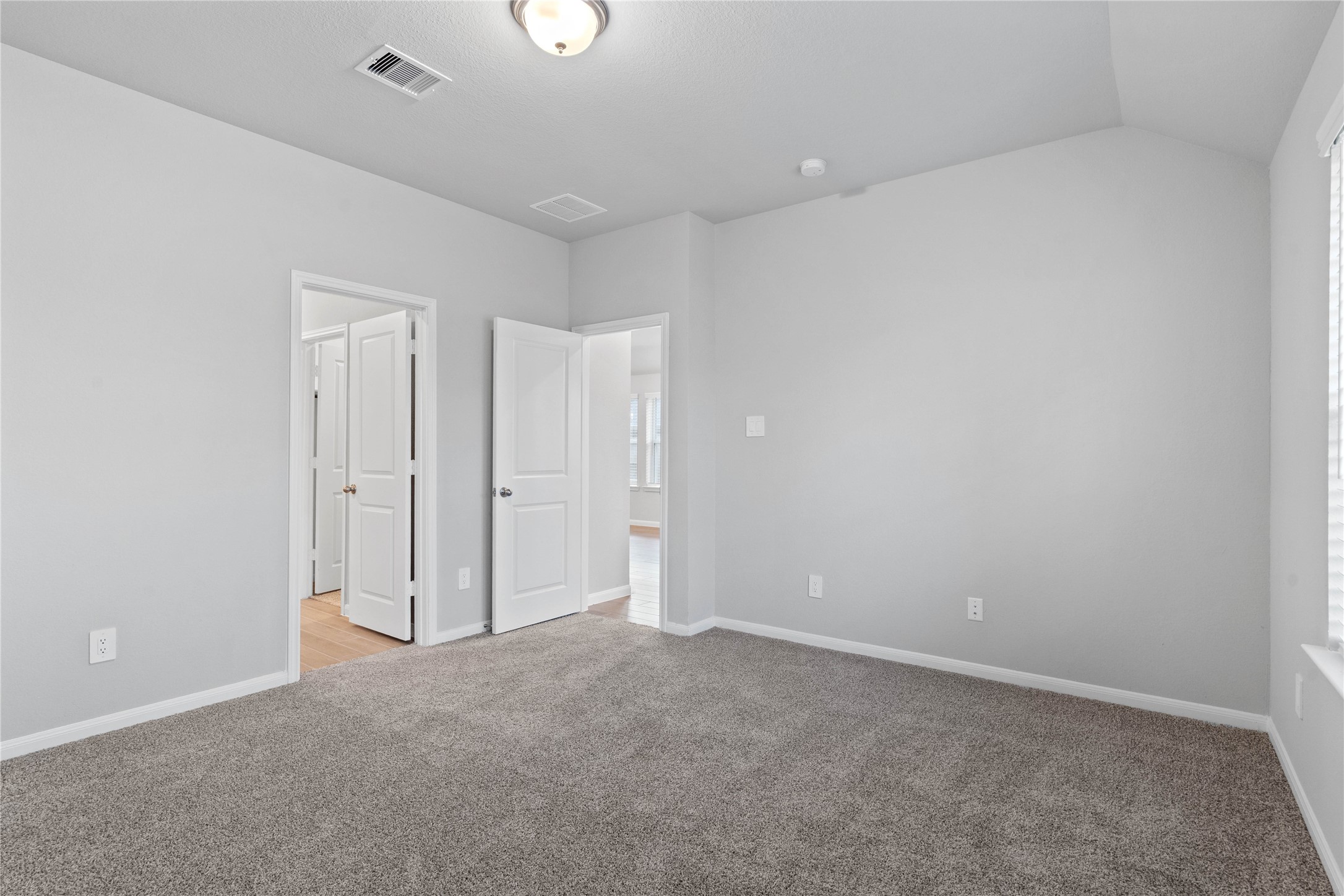 The private primary suite efficiently connects the sleeping area with the dedicated bathroom and generous closet.