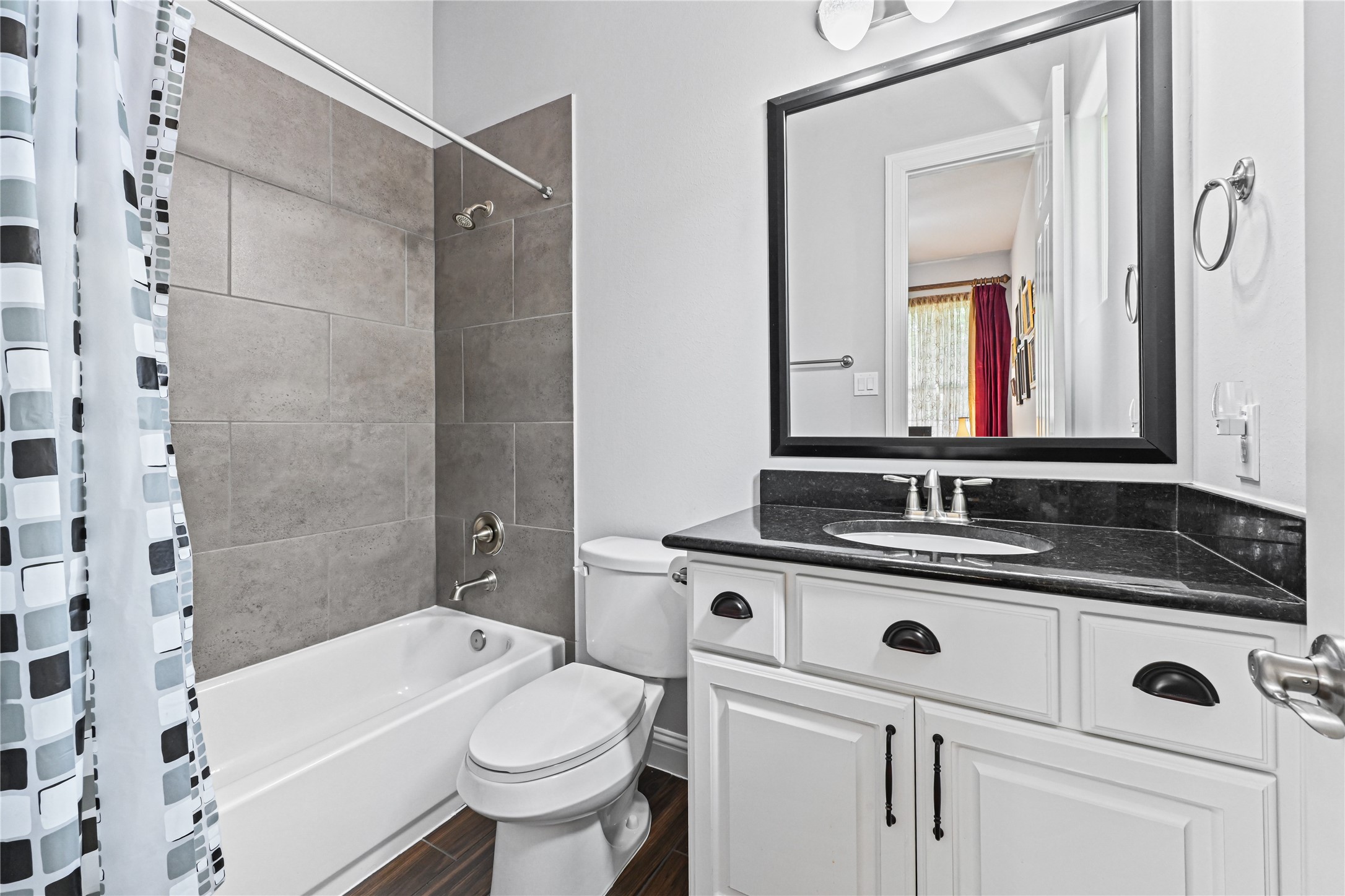The private Guest Suite bathroom is beautifully appointed with a spacious vanity offering plenty of drawer storage, gorgeous granite countertops & matching granite backsplash, deep undermount sink, stylish fixtures and a tub/shower combinationperfect for making your guests feel right at home!