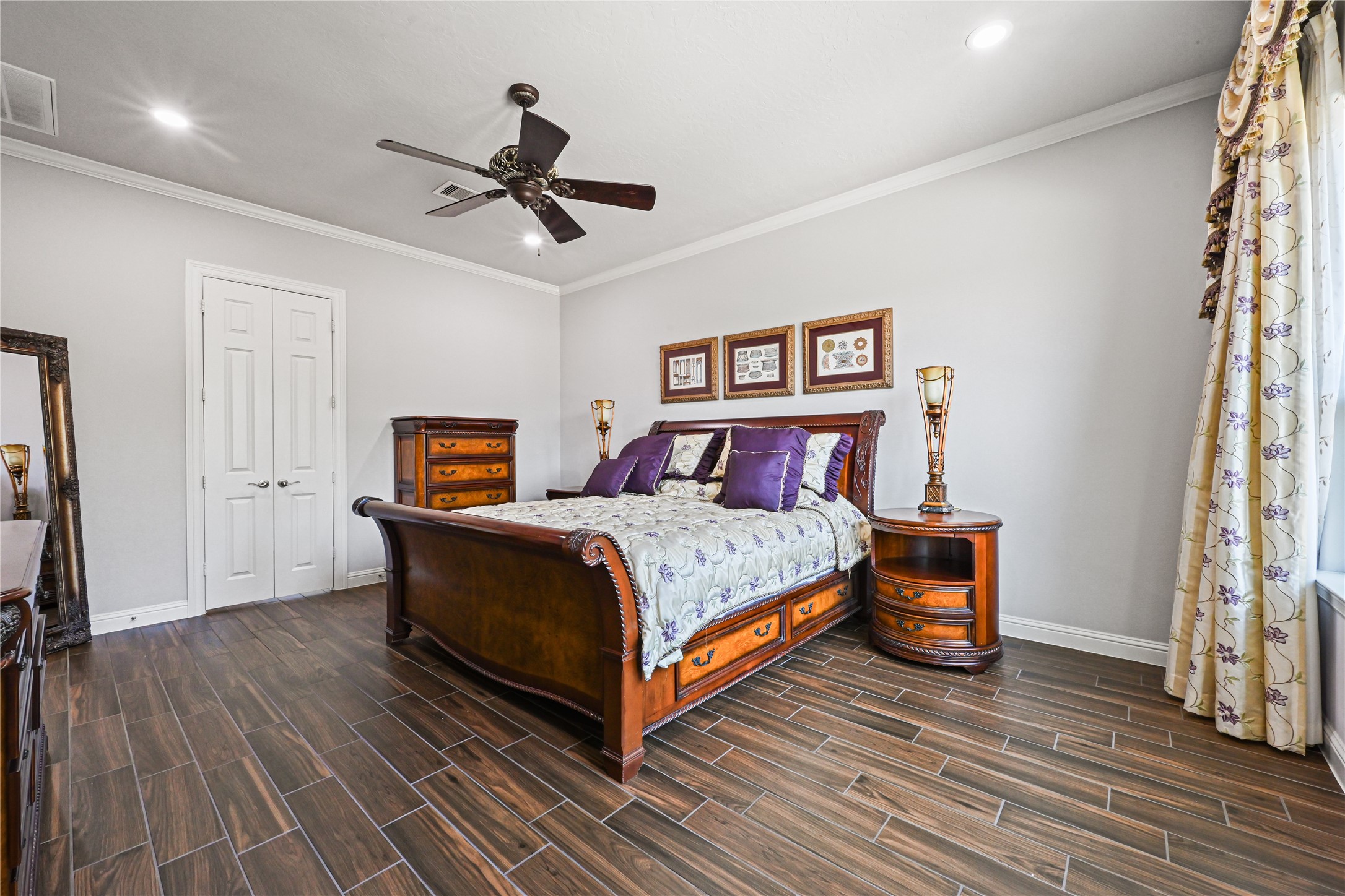 The stunning primary suite boasts dramatic high ceilings beautifully accented with elegant crown molding, creating a luxurious and relaxing retreat! French doors open to the impressive spa-inspired primary bathroom, thoughtfully designed for two. Your own private escape awaits at the end of every day!