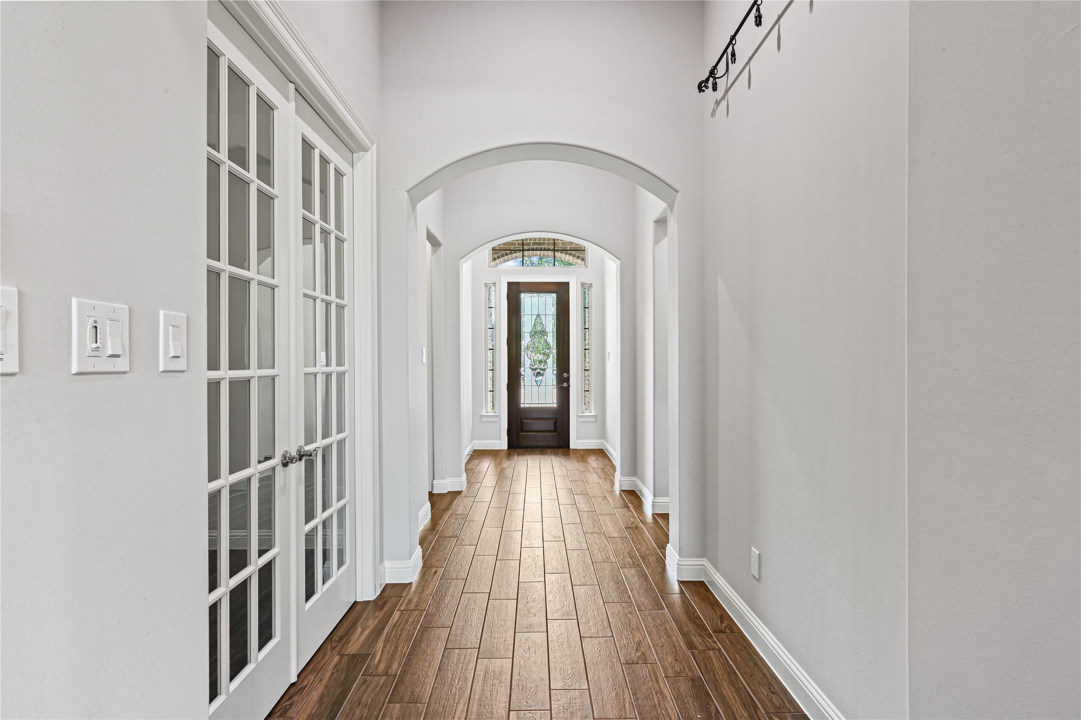 Continue down the hallway and discover impressive upgraded tall glass-panel doors opening to your private home office! A beautiful, light-filled space perfect for working from home, studying or simply staying organized. Every detail adds to the custom feel of this stunning homeand it could be yours with just one phone call!