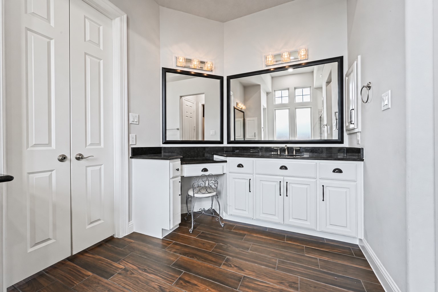 The luxurious spa-inspired primary bathroom features her own private vanity with a dedicated sitting areaperfect for getting ready in style! Gorgeous granite countertops, matching granite backsplash, deep undermount sink, medicine cabinet & an abundance of drawers provide exceptional storage. Beautiful, functional & thoughtfully designed with her in mind!