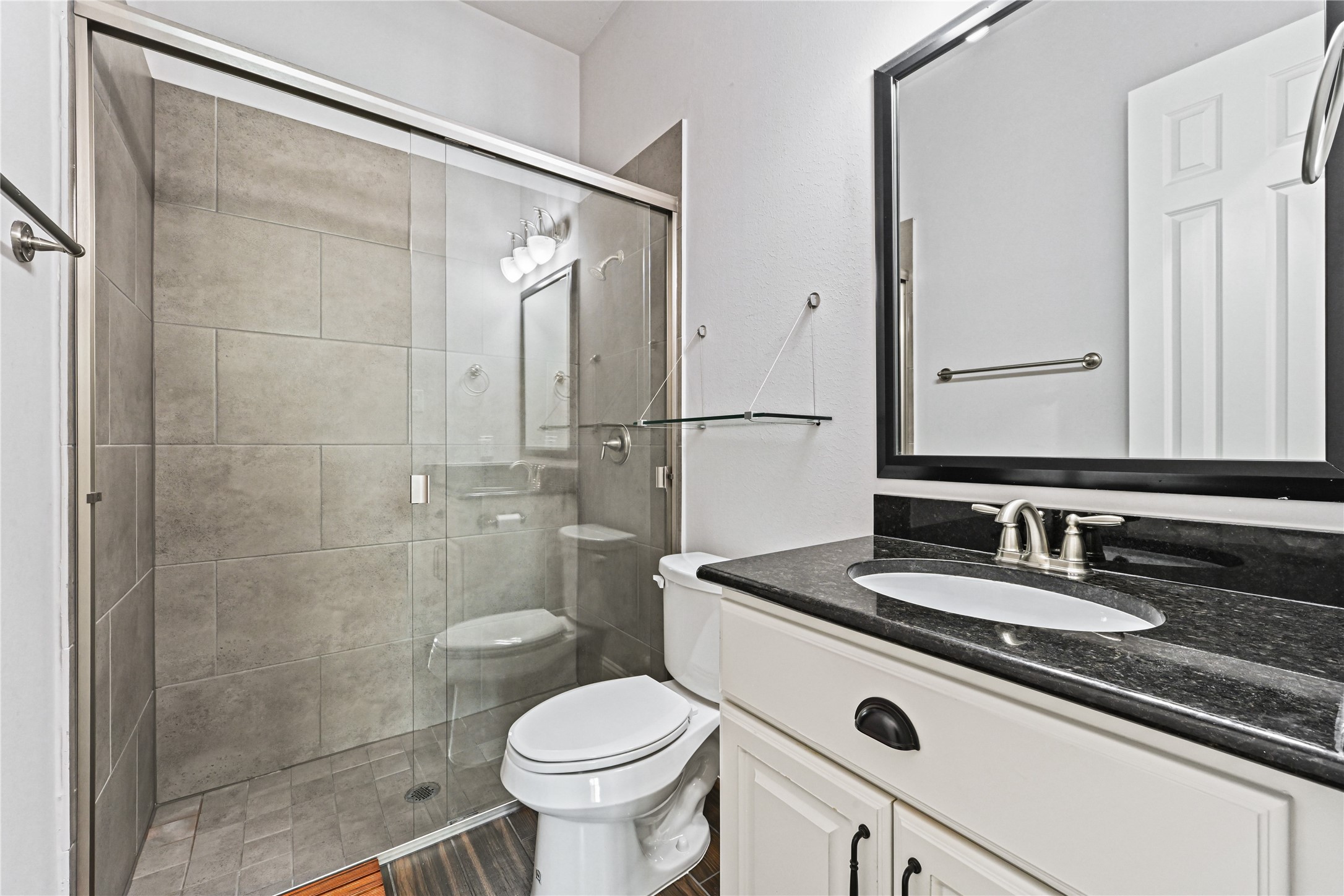 Yes, another beautiful full guest bathroom! Enjoy the extra-large walk-in shower featuring a seamless sliding glass door, stunning custom tile surround & tile flooring. Quality finishes and thoughtful details throughoutthis custom-built home was designed with style, comfort & lasting beauty in mind!