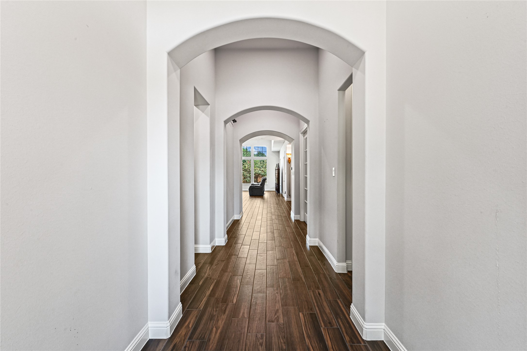 This stunning custom-built home welcomes you with a grand entry featuring dramatic high ceilings, impressive tall doorways & beautiful, carefree wood-look plank tile flooring! Continue down the hallway and discover a private guest suite thoughtfully tucked away for added comfort and privacy on the rightperfect for overnight guests or extended family!
