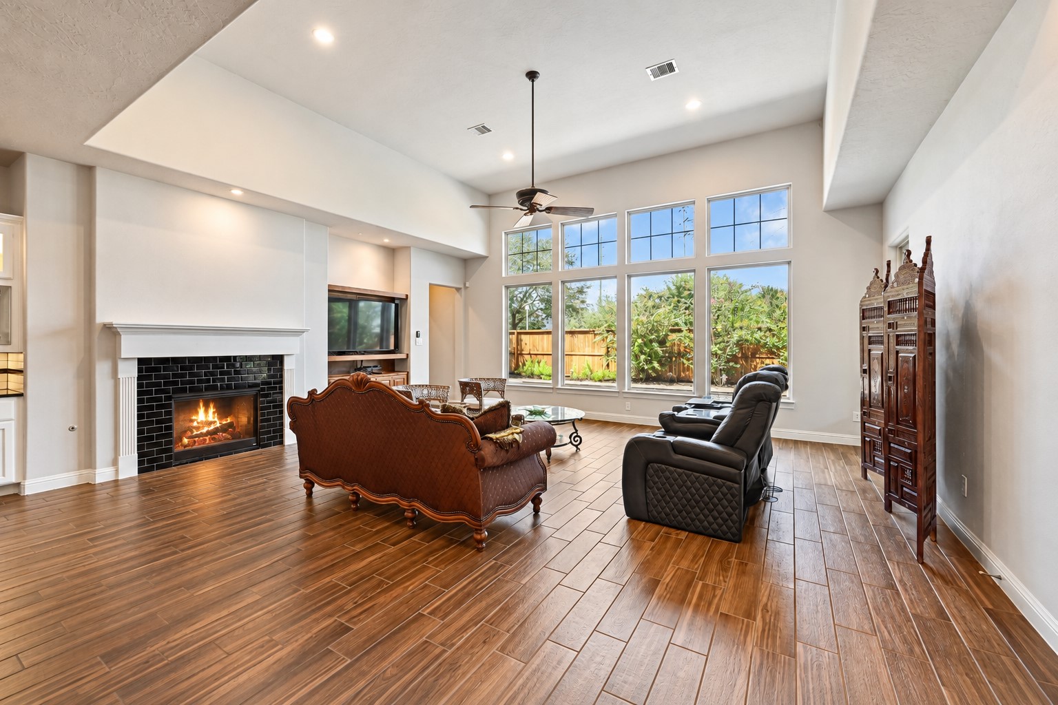 Dramatic high ceilings create an incredible sense of space, while the impressive custom fireplace adds warmth, character & a beautiful focal point to this stunning family room. Imagine gathering around the fireplace with family and friends during the upcoming holidayssimply breathtaking!