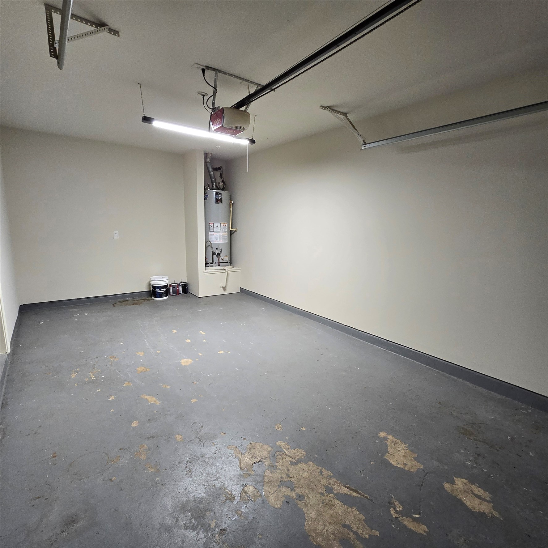 Garage with extra lighting, auto opener. Water heater.