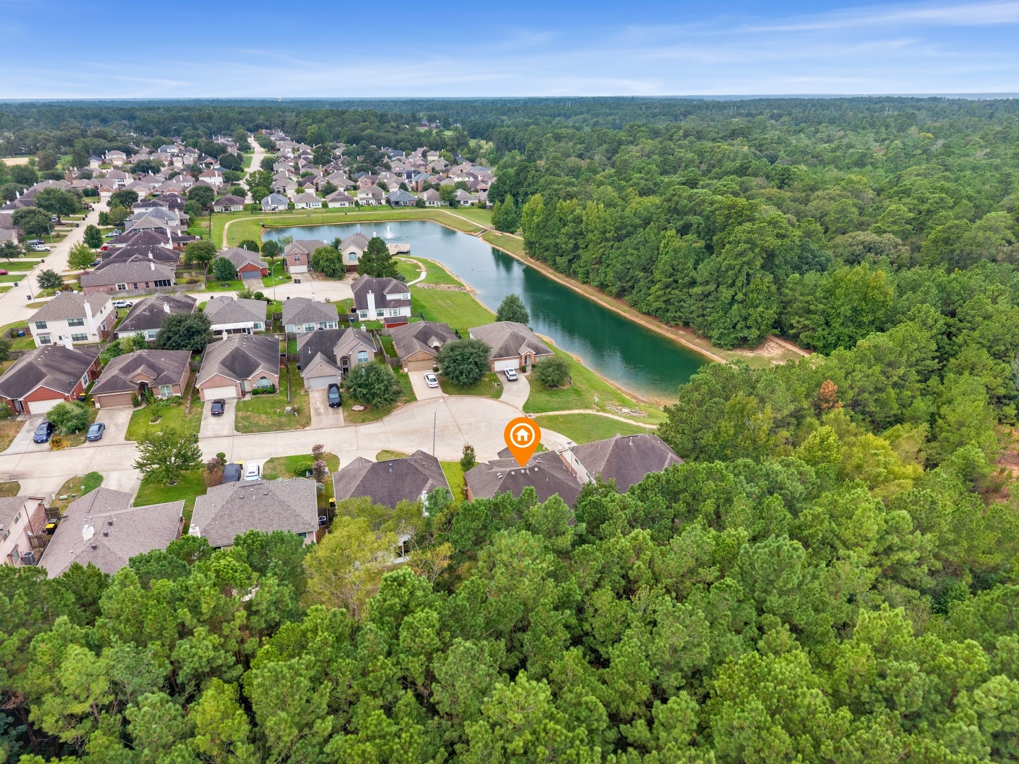 Wide aerial view highlighting the home's premier position backing directly to miles of lush green forest preserve with close proximity to a neighborhood pond and trails.