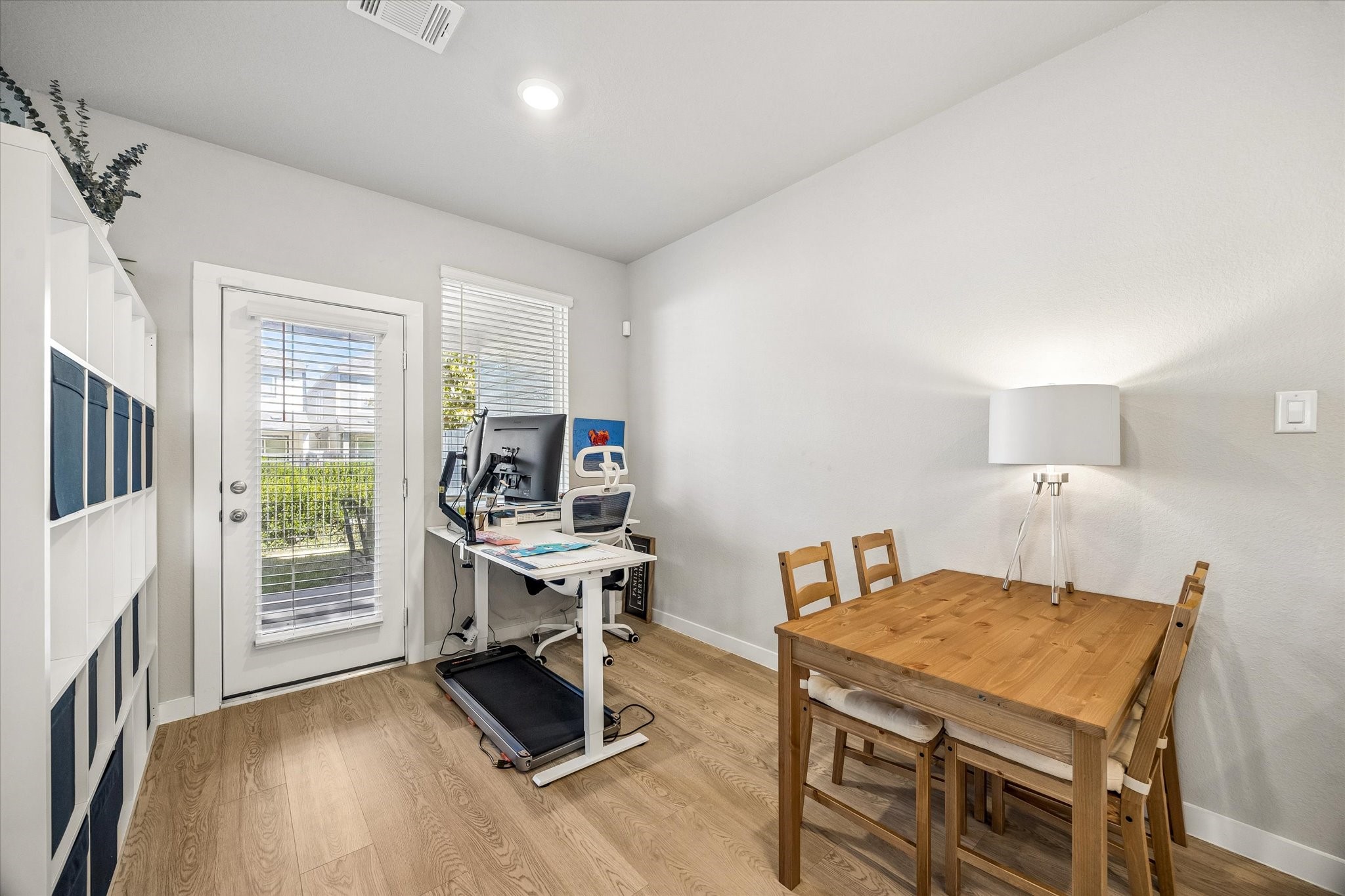 Traditionally designed as a dining room, this adaptable area is currently utilized as a home office, demonstrating its potential to accommodate different lifestyles and needs.