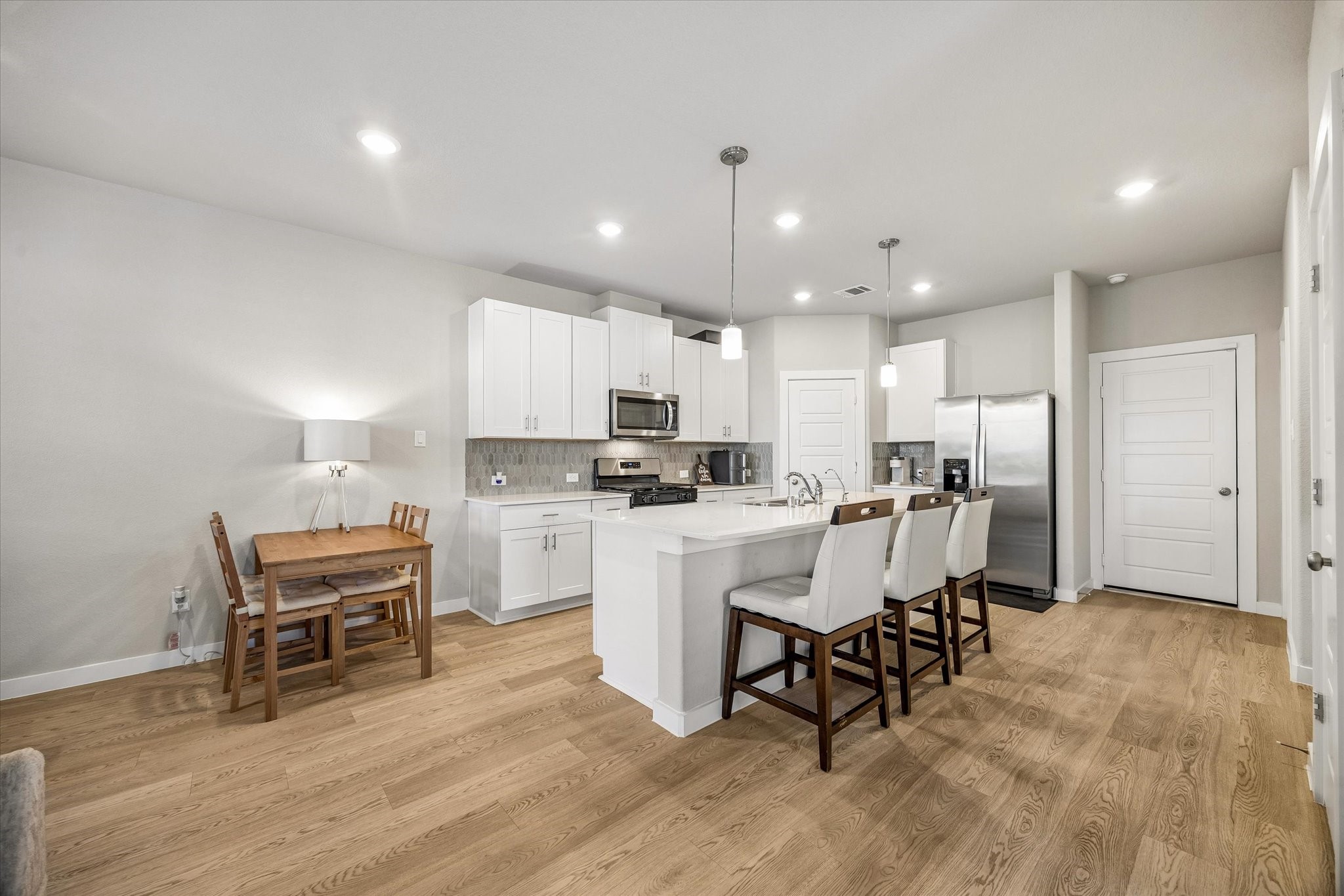 A wider perspective showcases the kitchen and its connection to the surrounding living spaces, creating an inviting atmosphere for daily activities and entertaining.