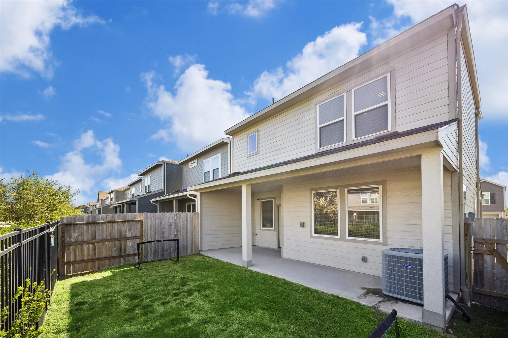 Another perspective of the backyard highlights the opportunity to enjoy time outdoors, whether soaking up the sunshine or winding down in the evening.