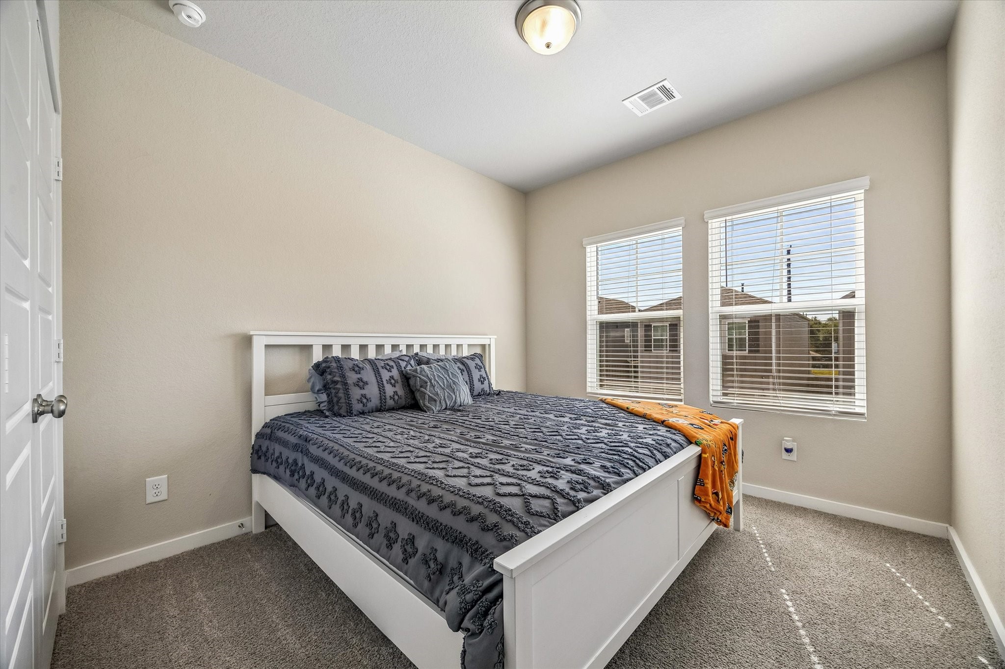 Additional bedroom adds flexibility to the floor plan, whether envisioned as a restful retreat, hobby room, or personal workspace.