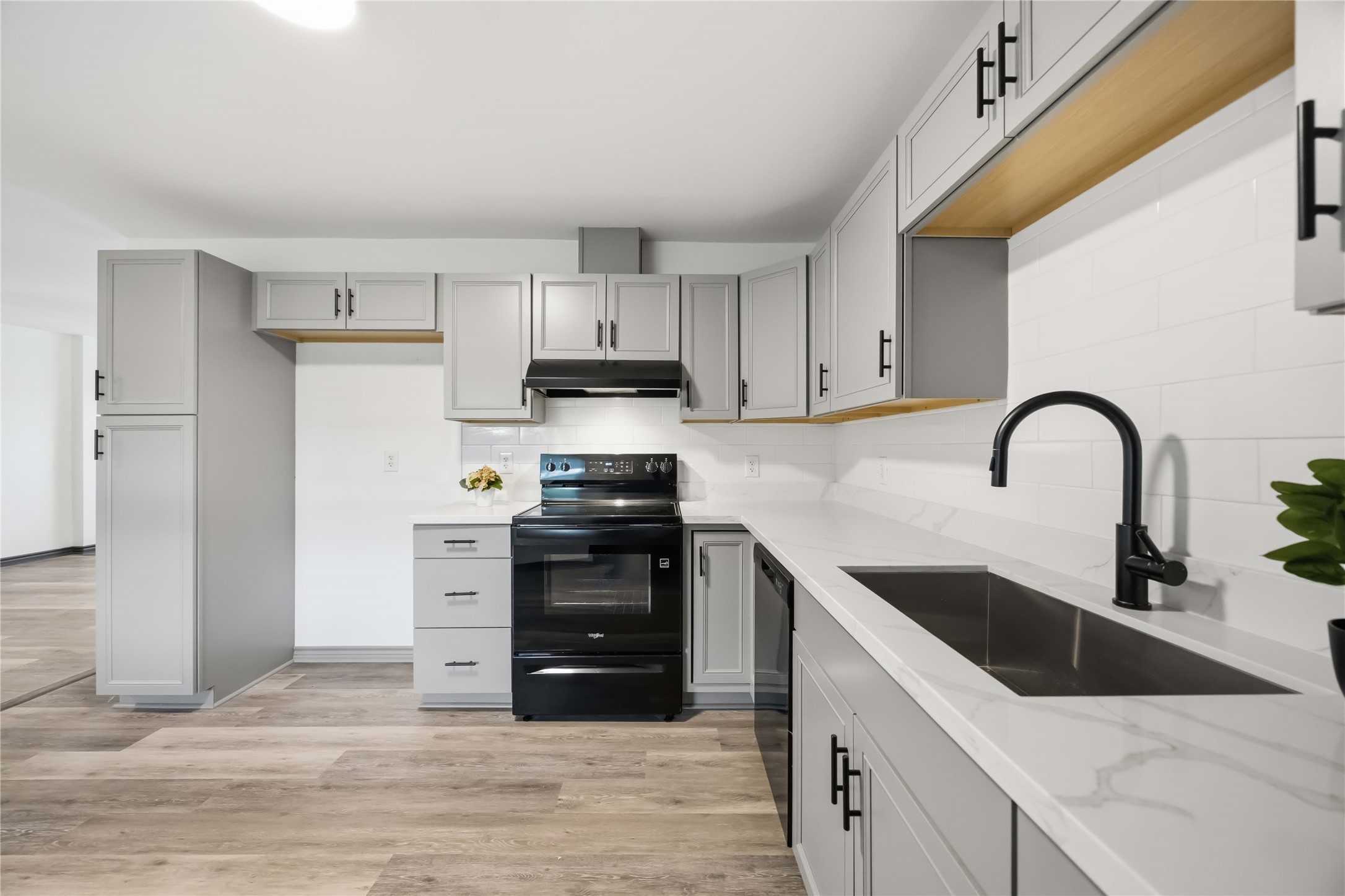 Another view of the counters and stainless steel sink.