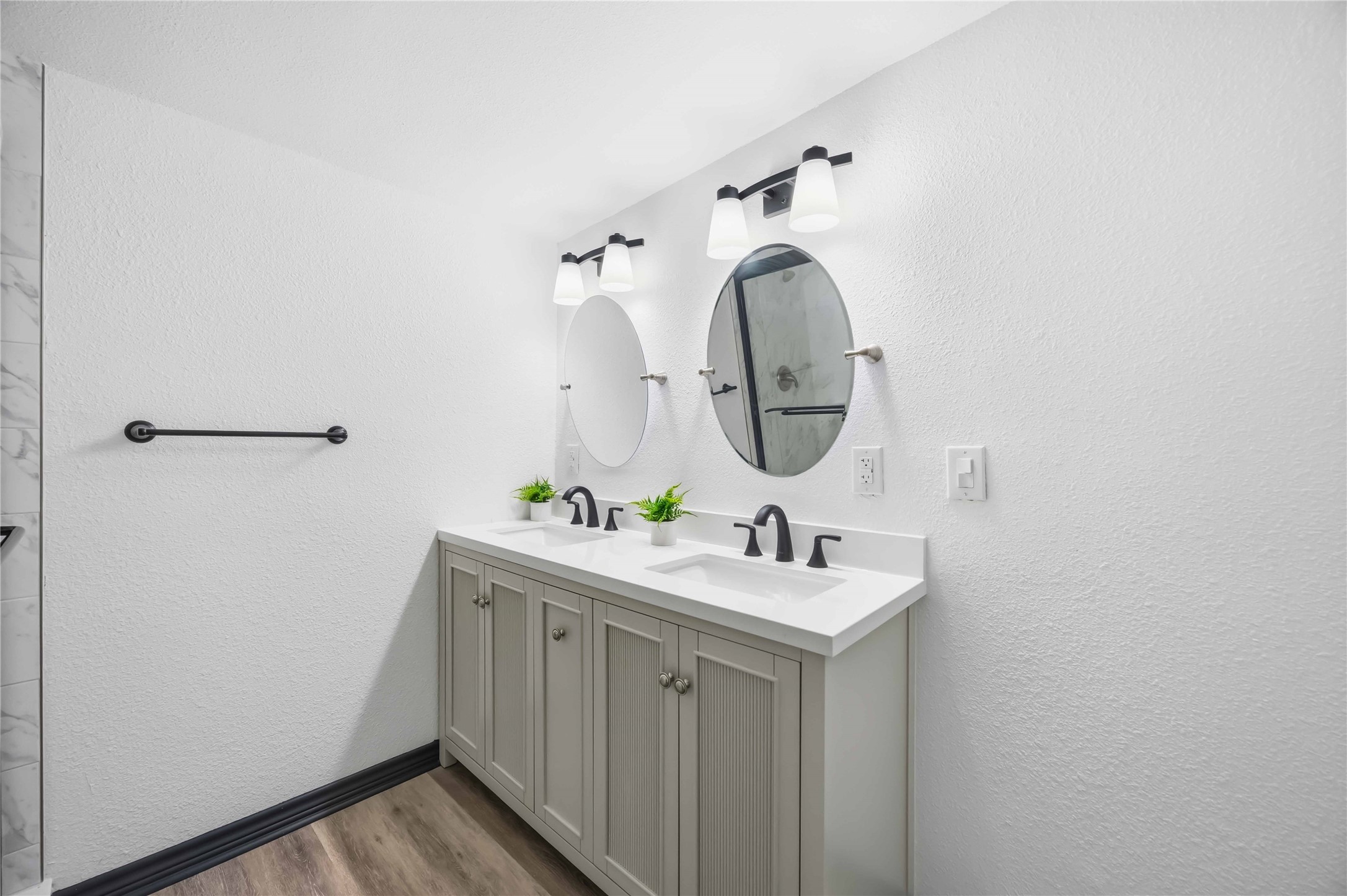 Another view of this primary bedroom with pendant lighting.