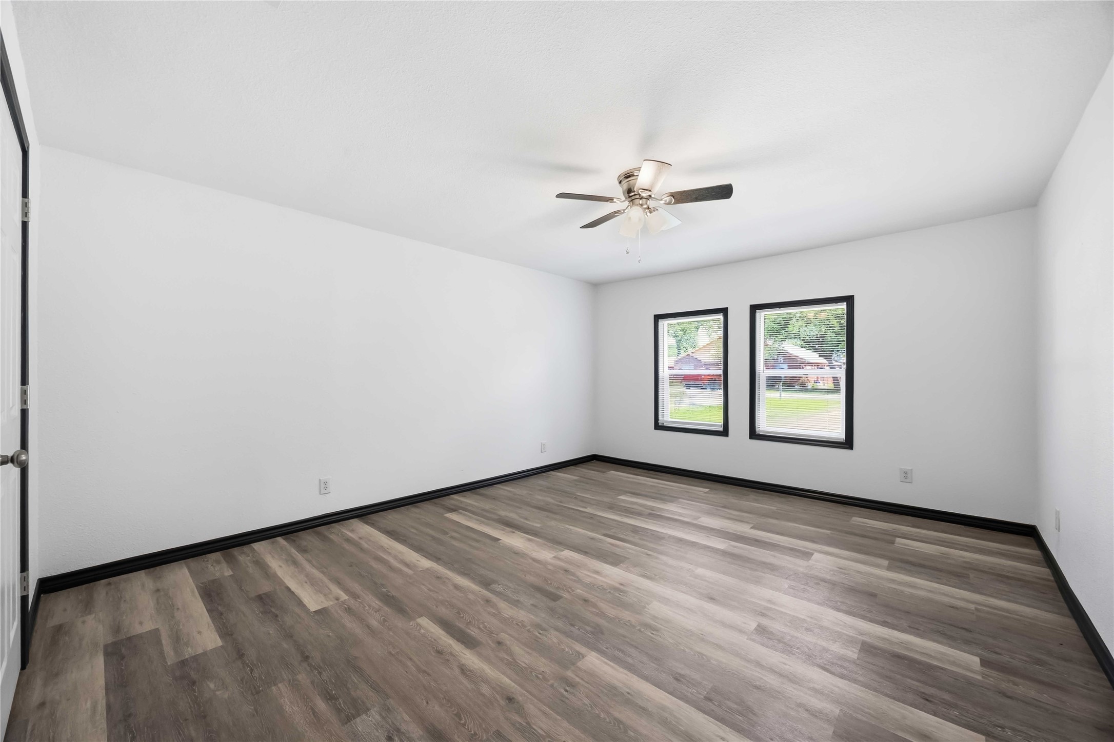 Converted garage that is now a bedroom with views of the front yard.