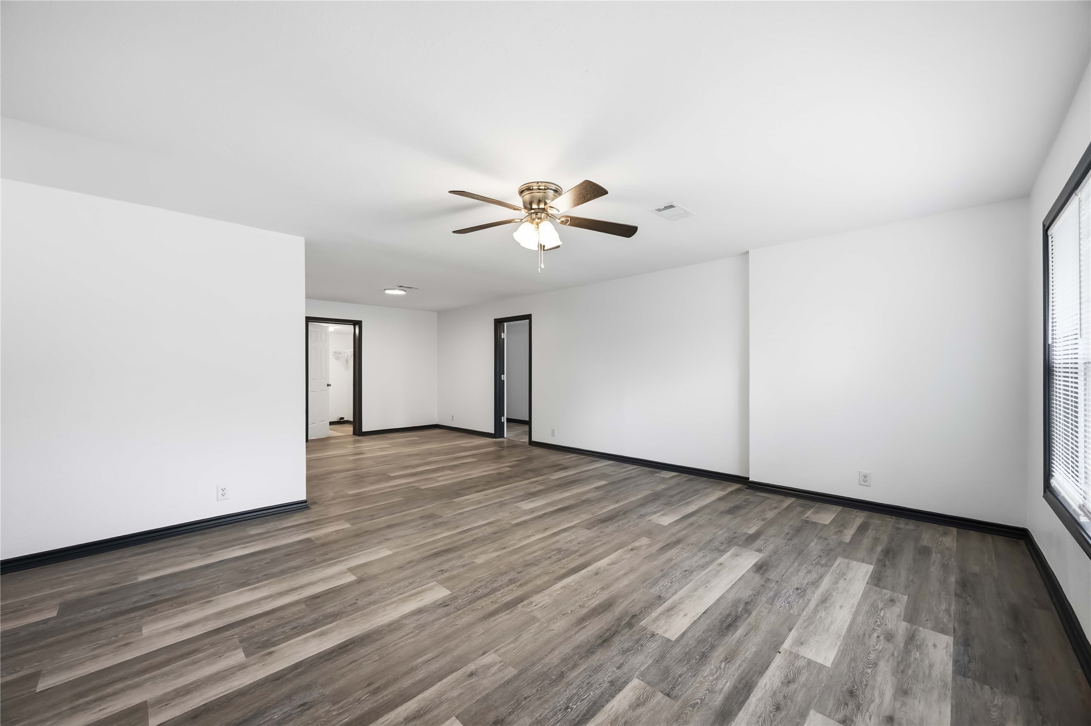 Opene door in the middle leads to the converted garage that is now a bedroom.