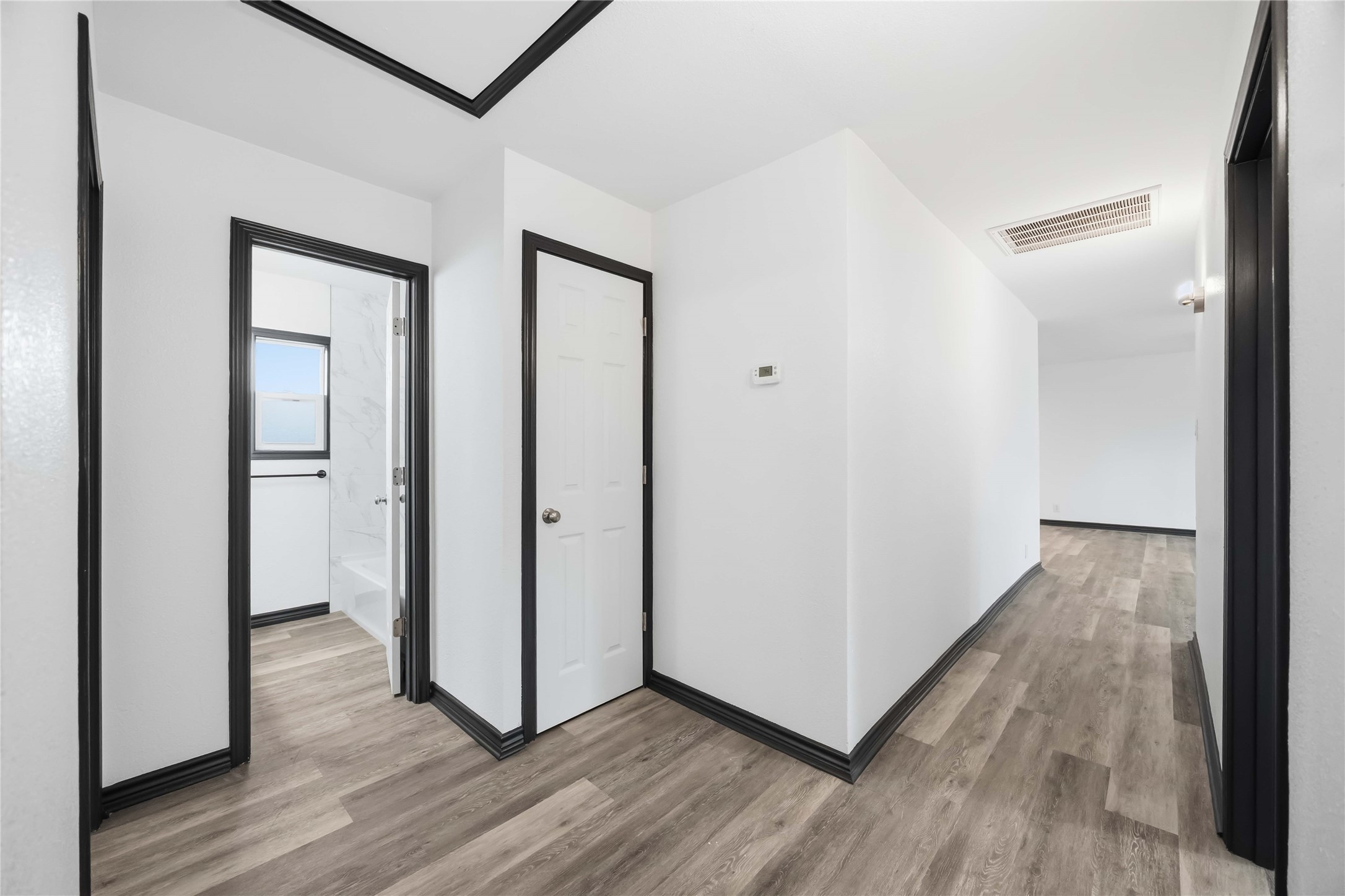 Through the hallway, three bedrooms and three baths with a coat closet in the hallway.