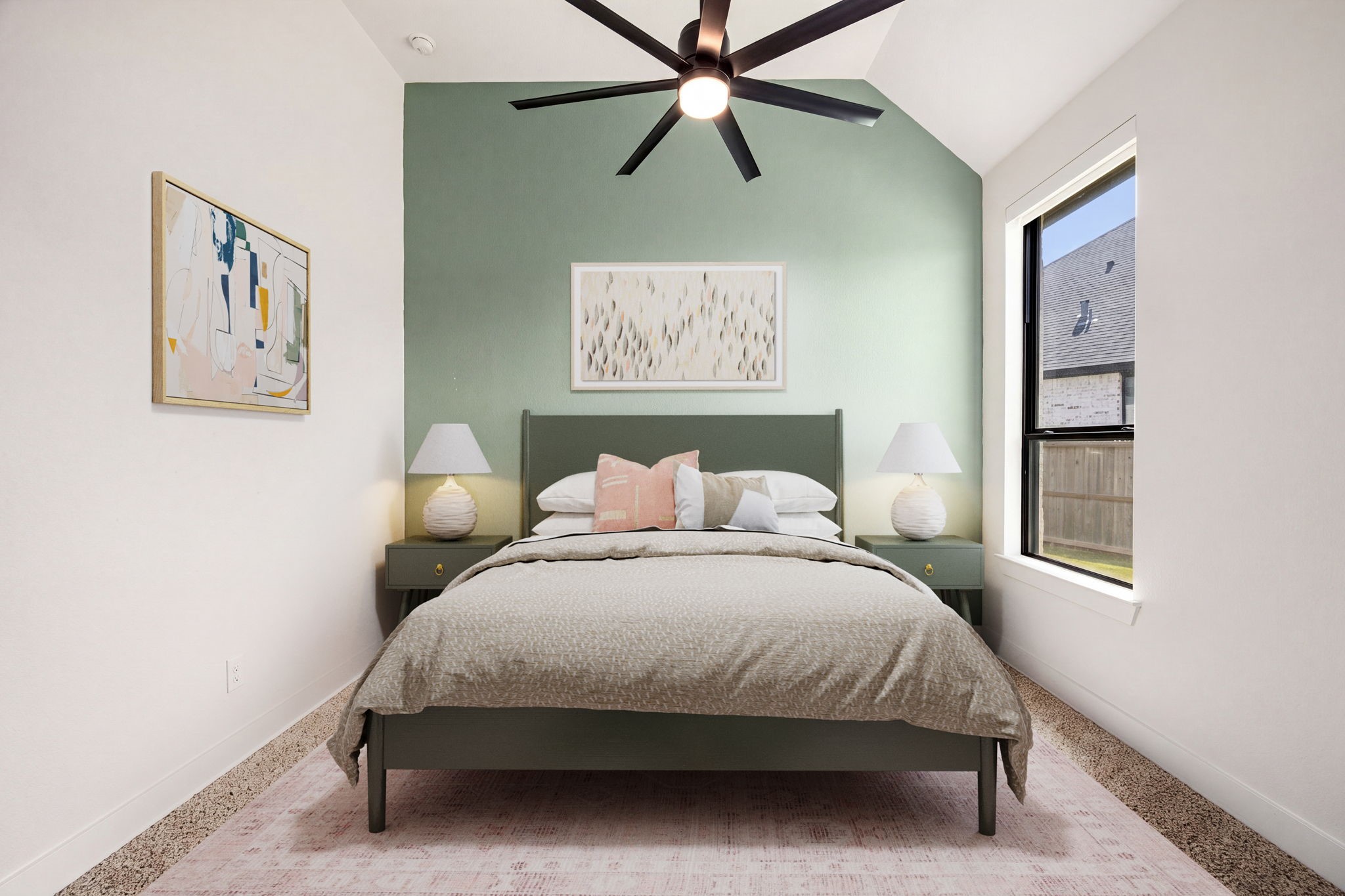 A stylish bedroom with custom details. A soft sage green accent wall serves as a beautiful backdrop, complemented by a dramatic vaulted ceiling, a black-trimmed vertical window, blackout shades, wide-plank flooring, and a modern multi-blade ceiling fan.