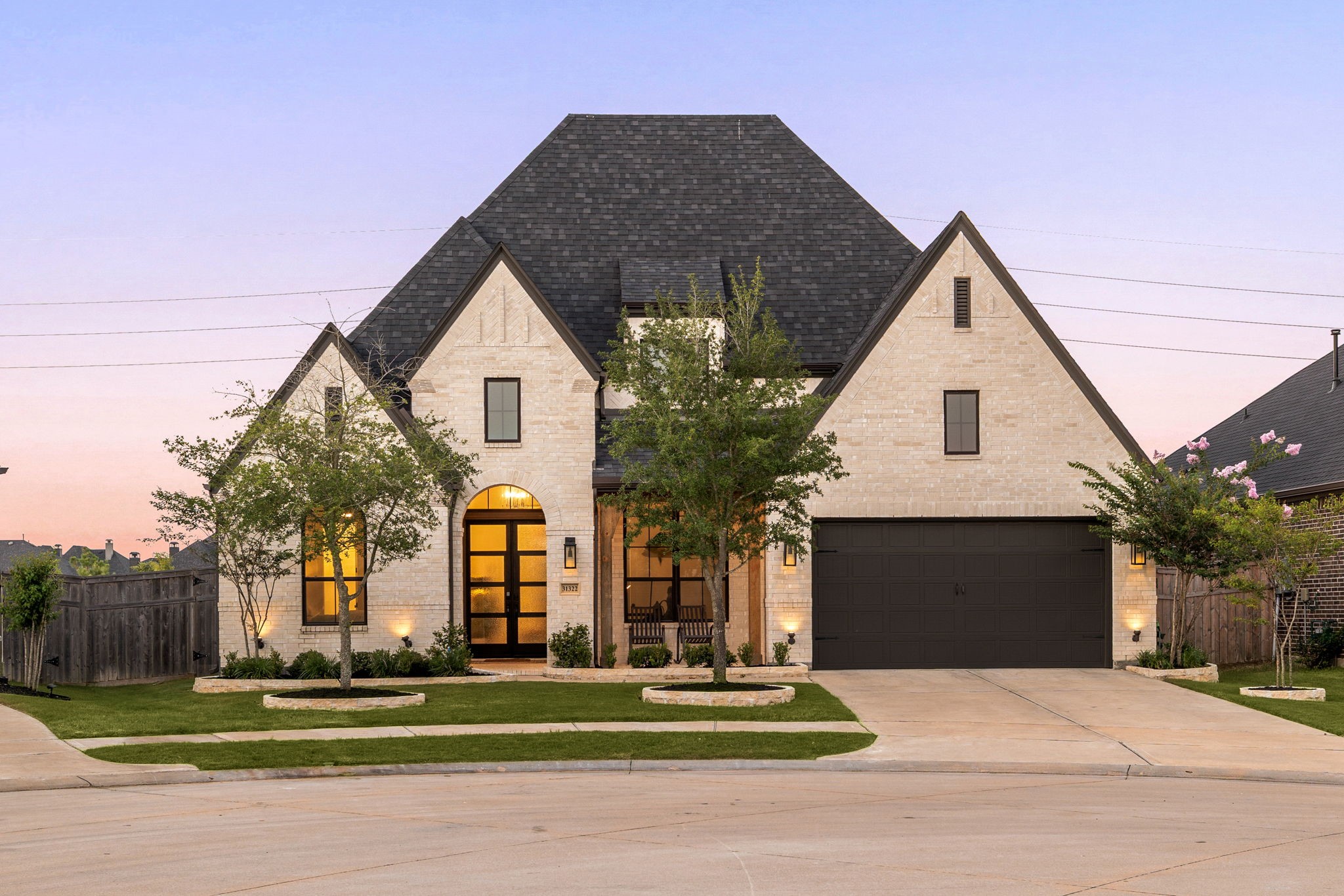 Welcome home to 31322 Crescent Hill Lane, tucked on a quiet cul-de-sac in Cross Creek West and zoned to Lamar Consolidated ISD! This stunning Highland Home showcases timeless curb appeal with a manicured lawn, lush landscaping, brick elevation, and elegant 4-pane French double doors. A covered front porch, classic traditional styling, outdoor lantern lighting, and a wide double driveway complete this inviting first impression.