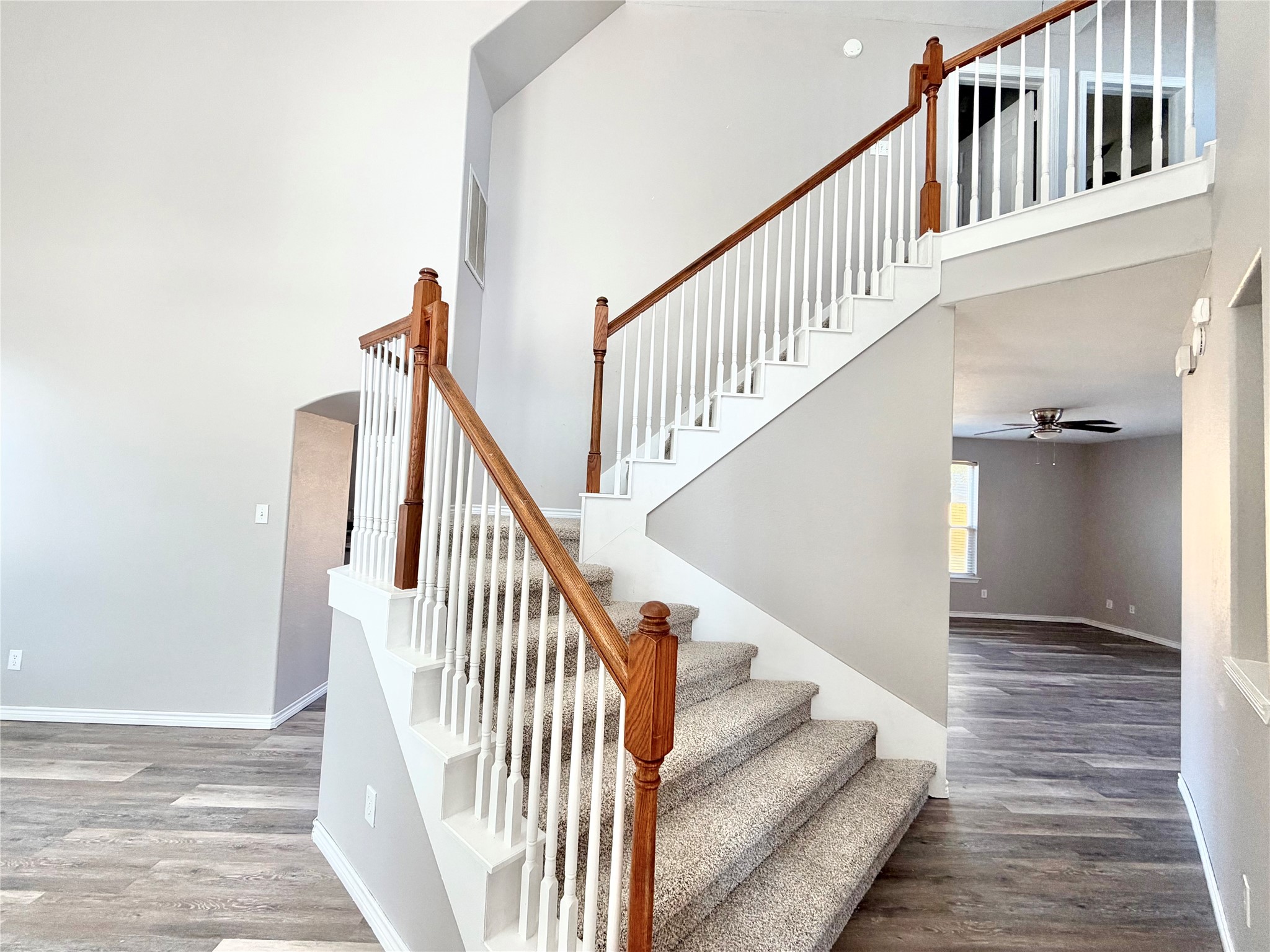 Stately grand staircase is just waiting for family pictures!  New carpet there as well.