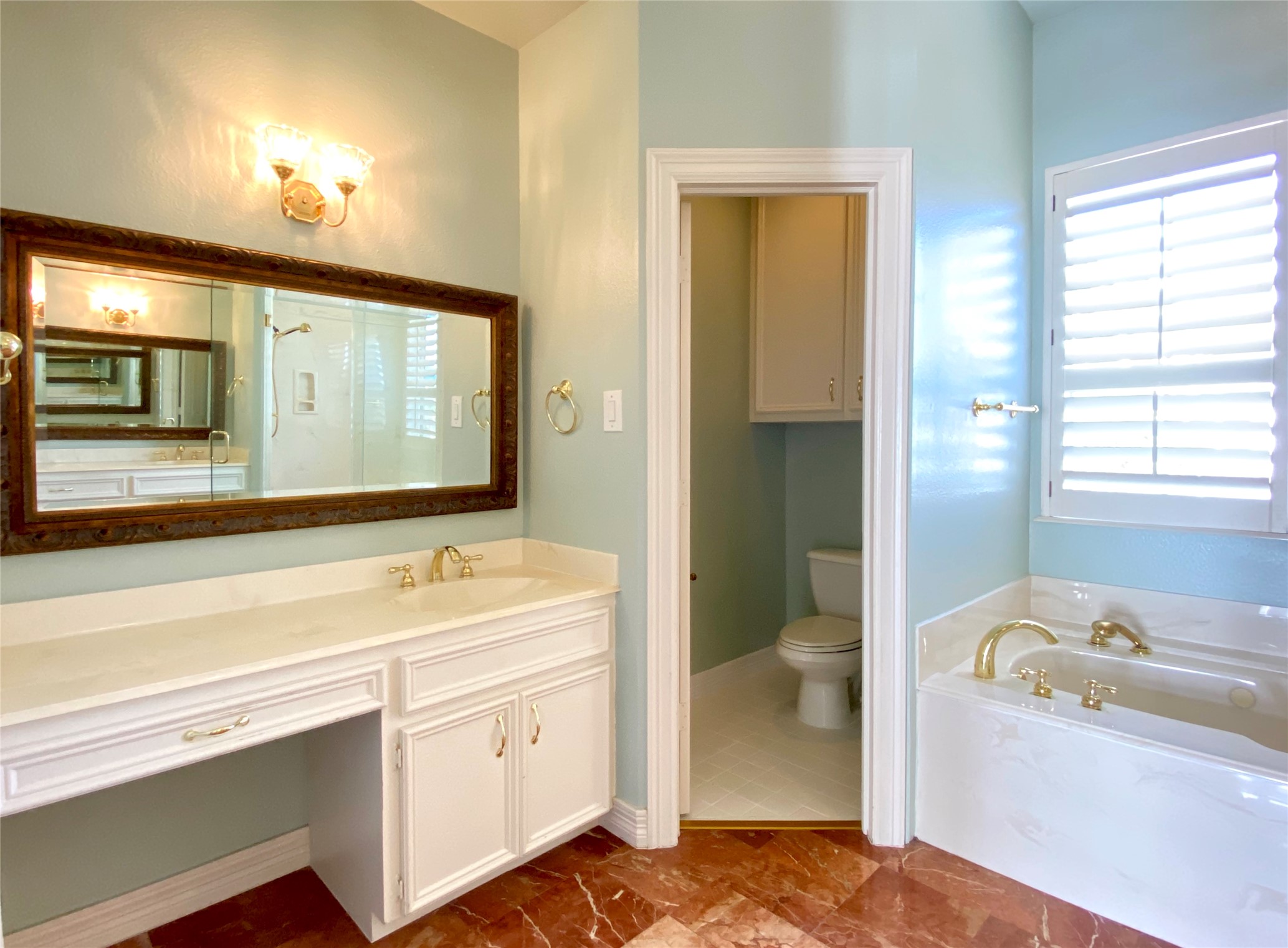 The opposite side of the primary bath with separate water closet space.