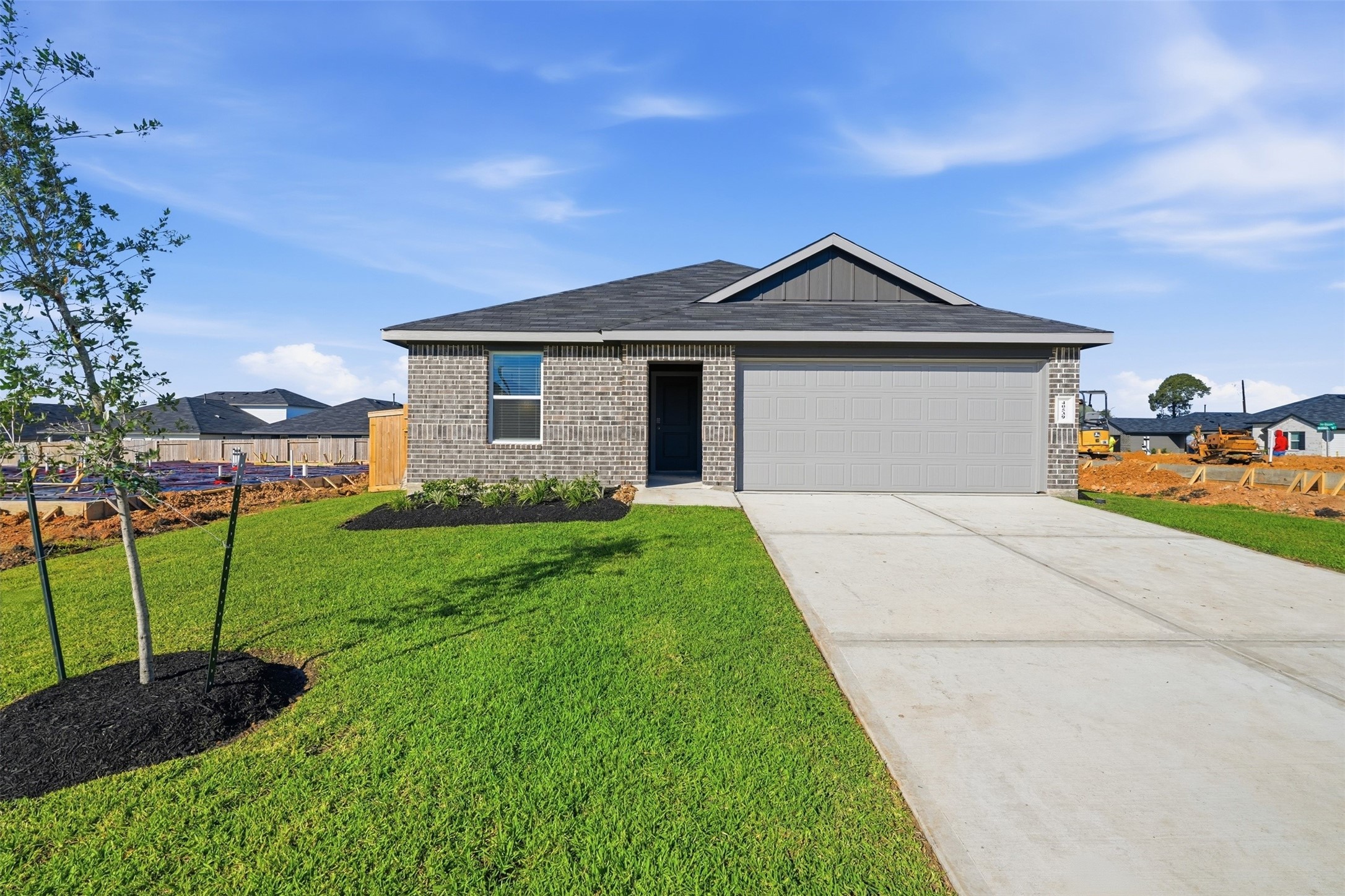 Charming modern home with a sleek brick exterior, two car garage.