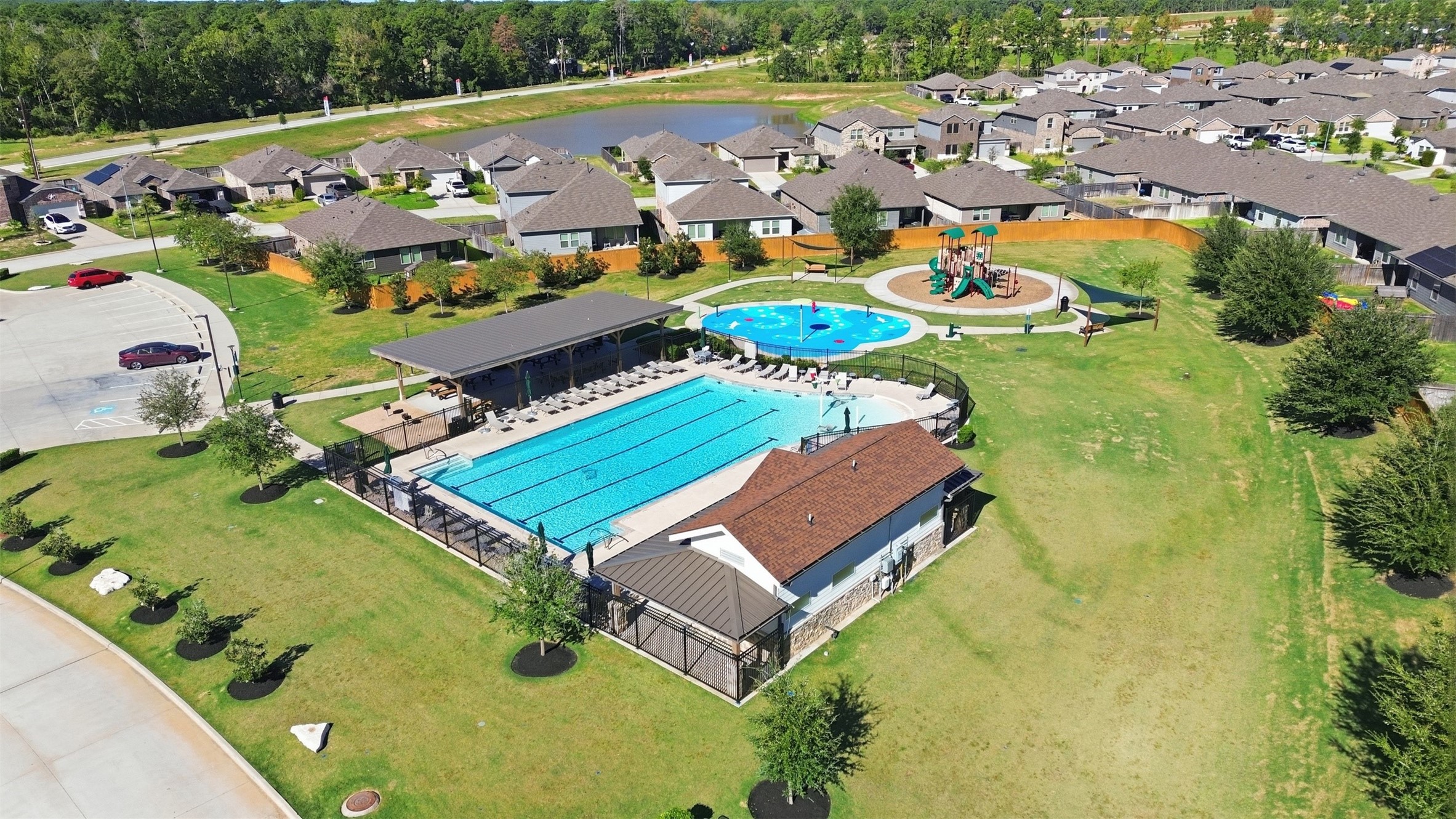 Discover a vibrant community featuring a sparkling swimming pool, a playful splash pad, and a well-equipped playground, all surrounded by beautifully landscaped green spaces and charming homes.
