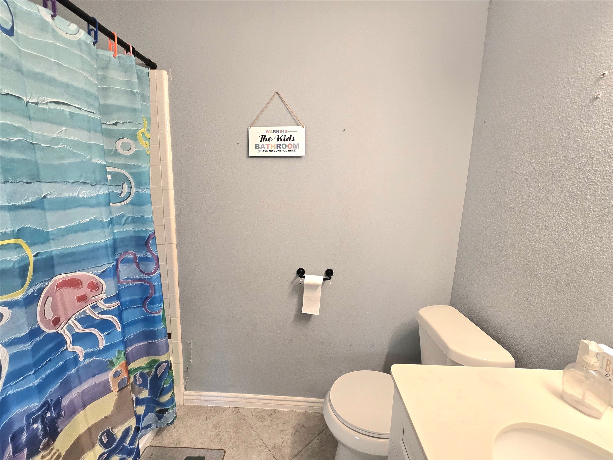 Charming bathroom featuring a white vanity and soft gray walls for a bright and cheerful atmosphere.