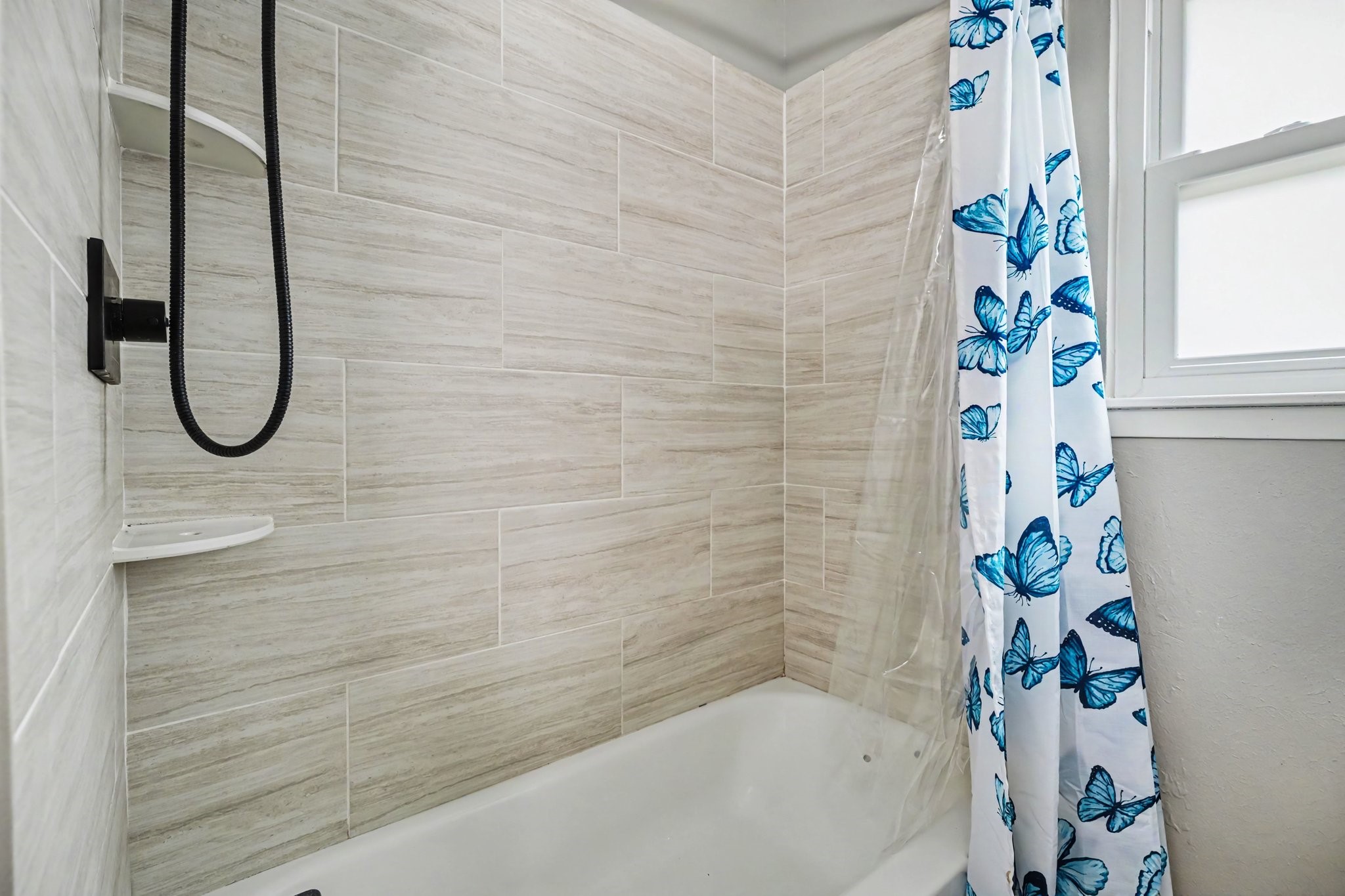 Shared Modern bathroom with elegant tilework offering a fresh and inviting space.