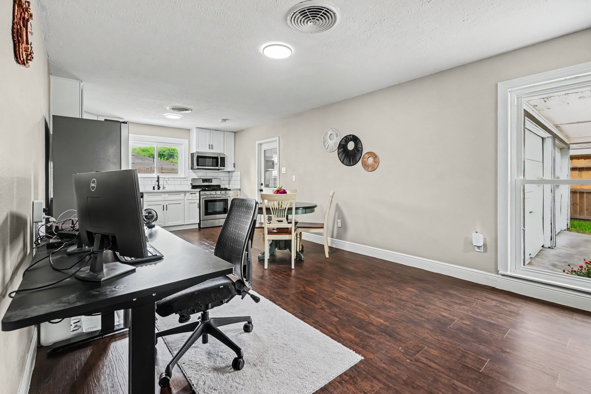 Bright and open kitchen with modern appliances and ample counter space, seamlessly connected to a cozy dining area and adjacent home office nook. Bright and open kitchen with modern appliances and ample counter space, seamlessly connected to a cozy dining area and adjacent home office nook.