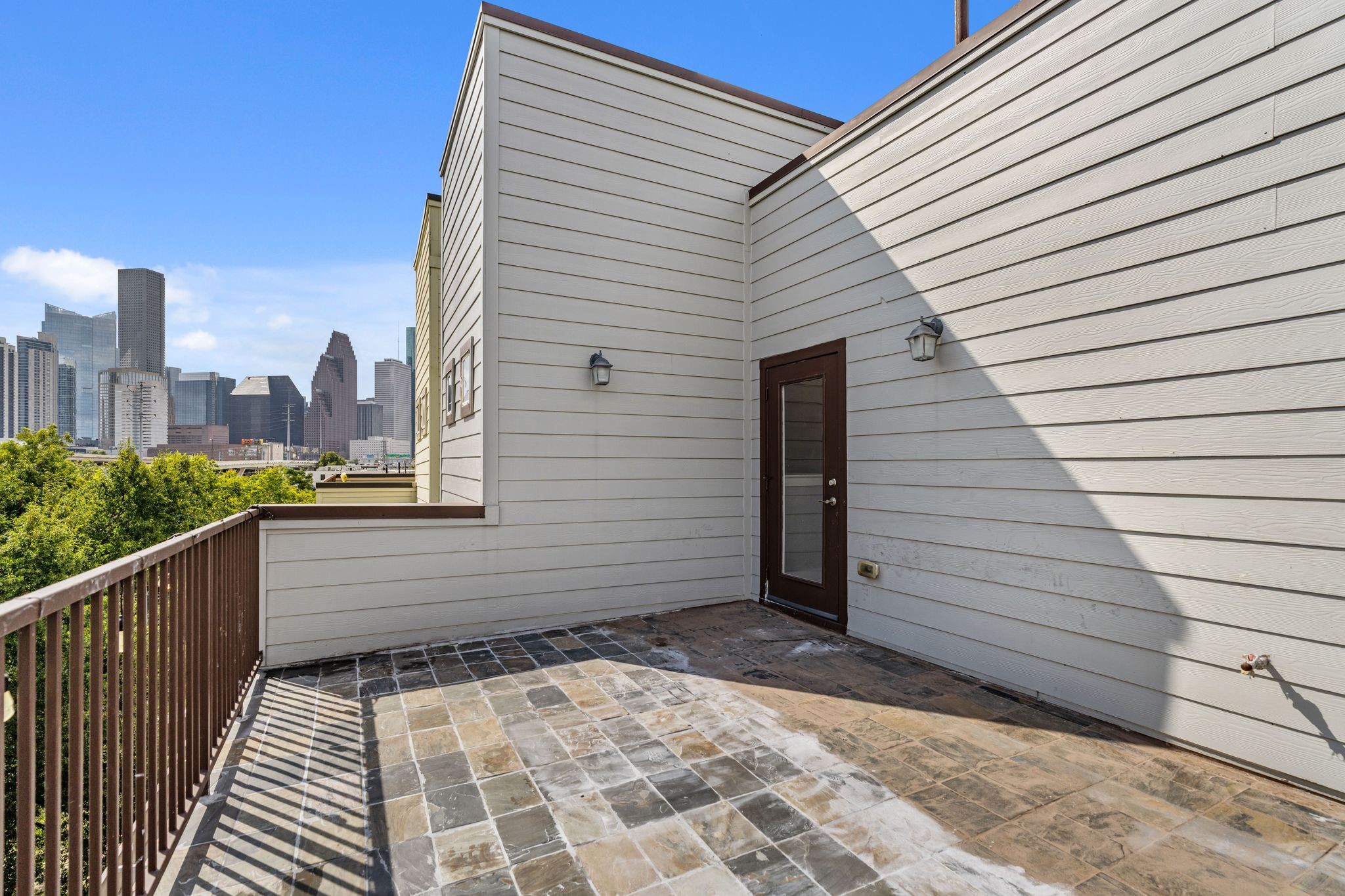 Fourth-floor terrace with views of the Downtown Houston skyline, offering an outdoor space for relaxing or entertaining.