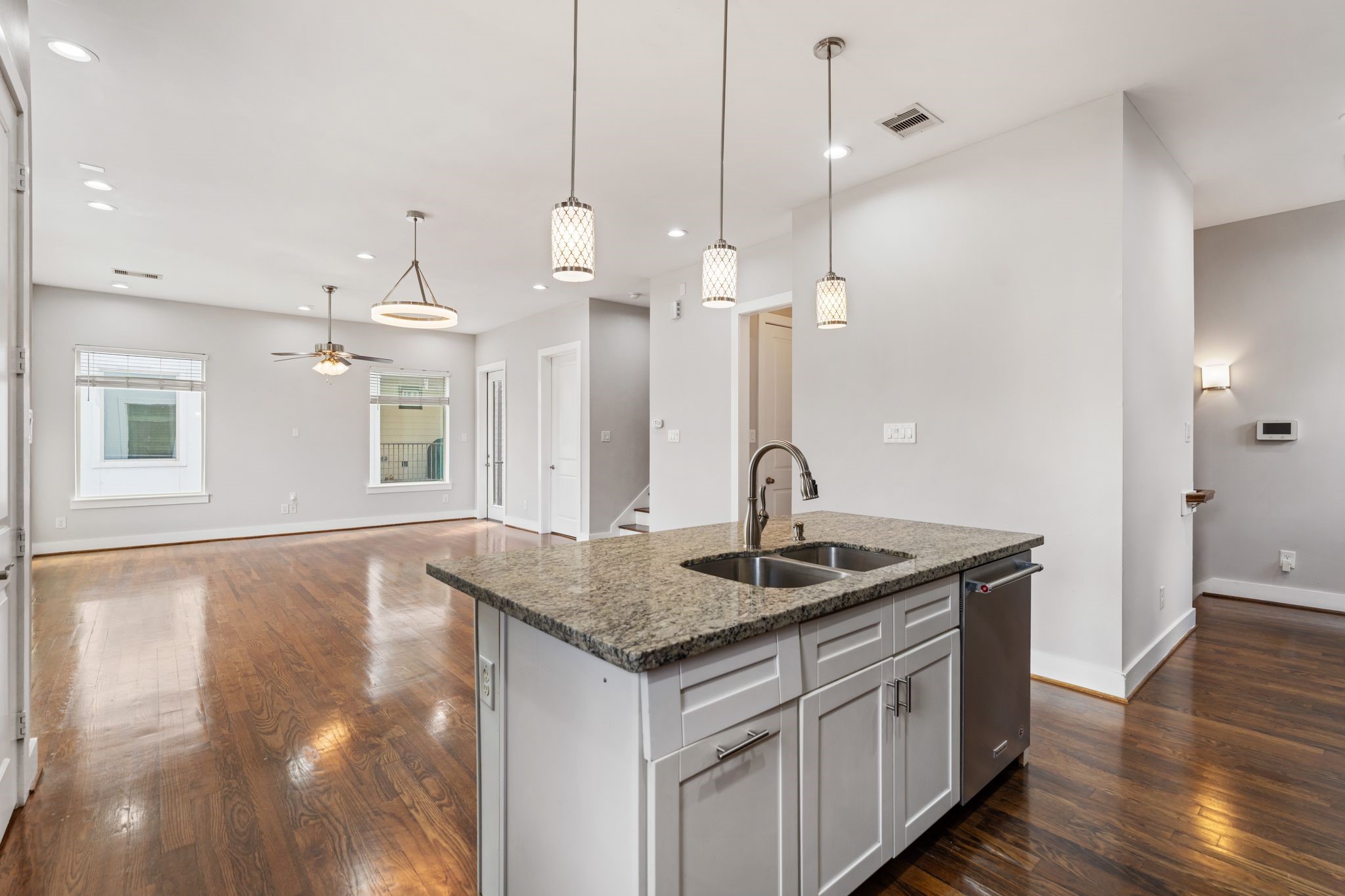 The kitchen opens to the living and dining areas with hardwood floors throughout.