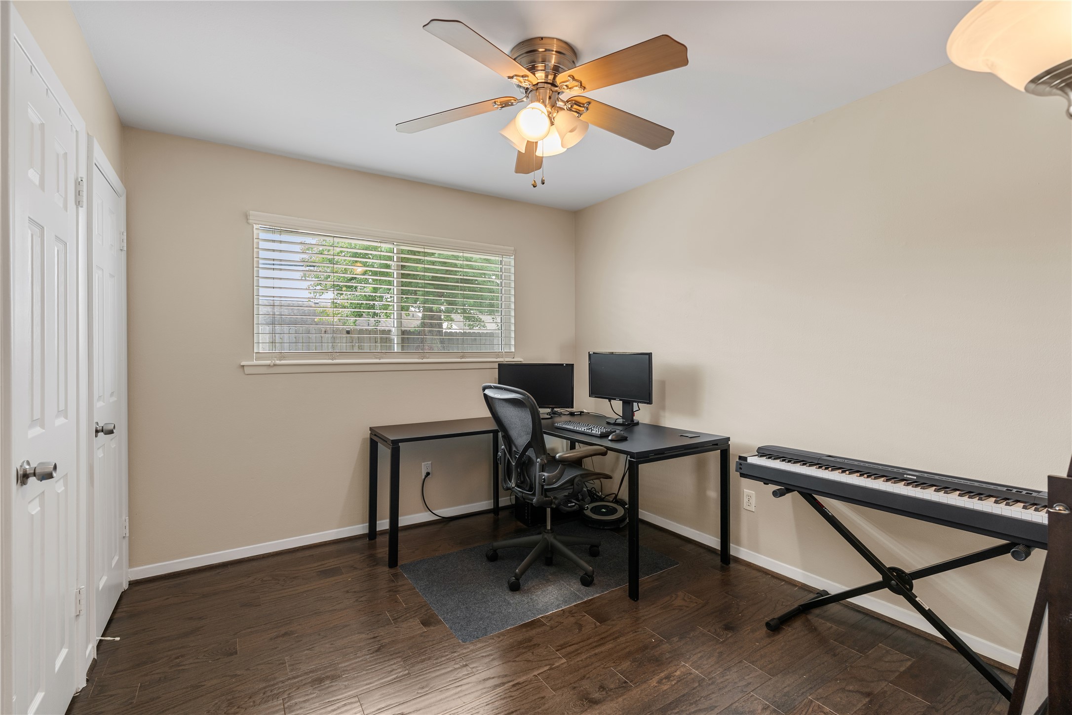 3rd secondary bedroom with natural light, hardwood floors, and a reach-in closet.