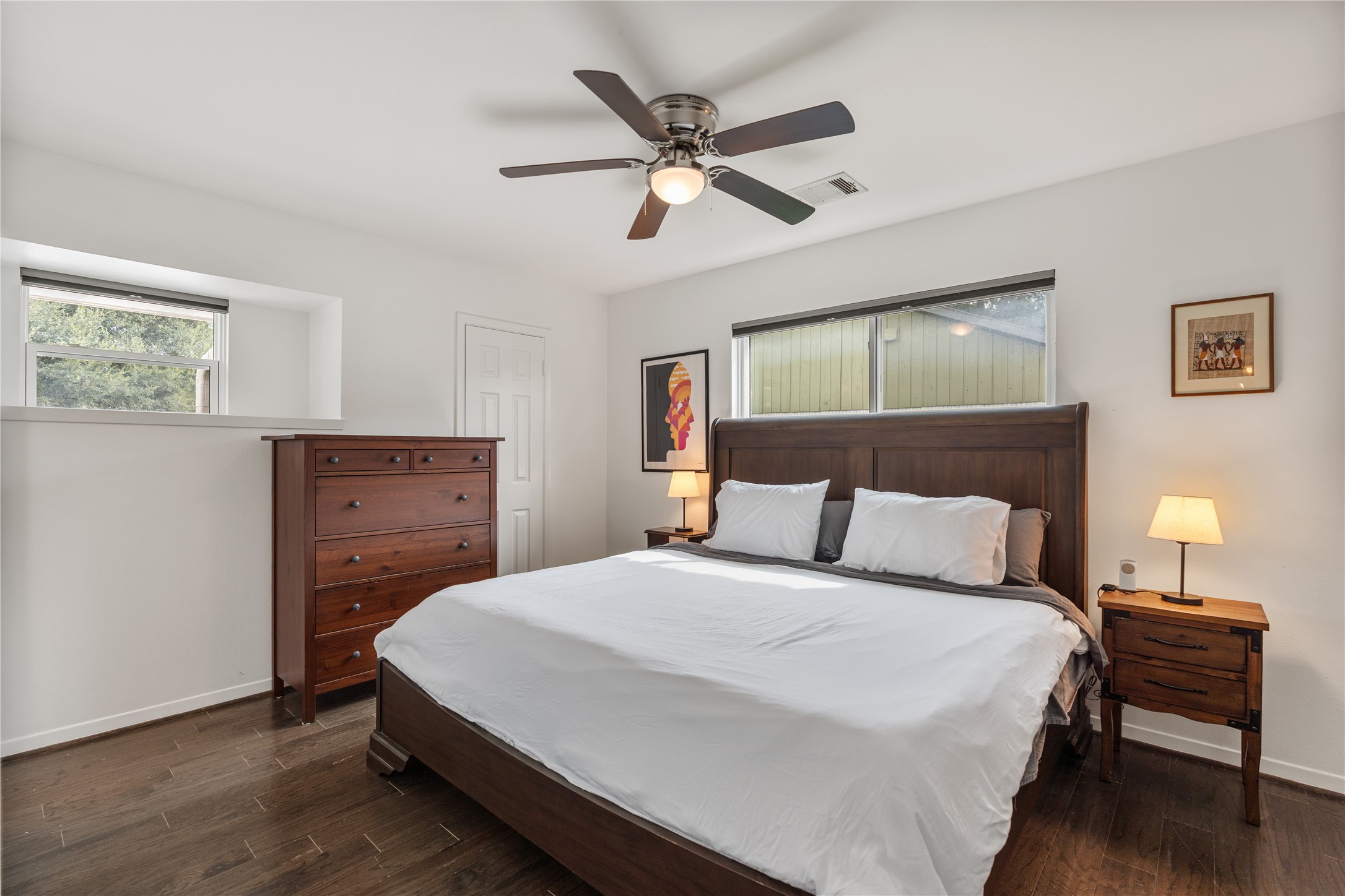 Primary bedroom tucked into the back of the home with ample natural light, walk-in closet and ensuite bath.